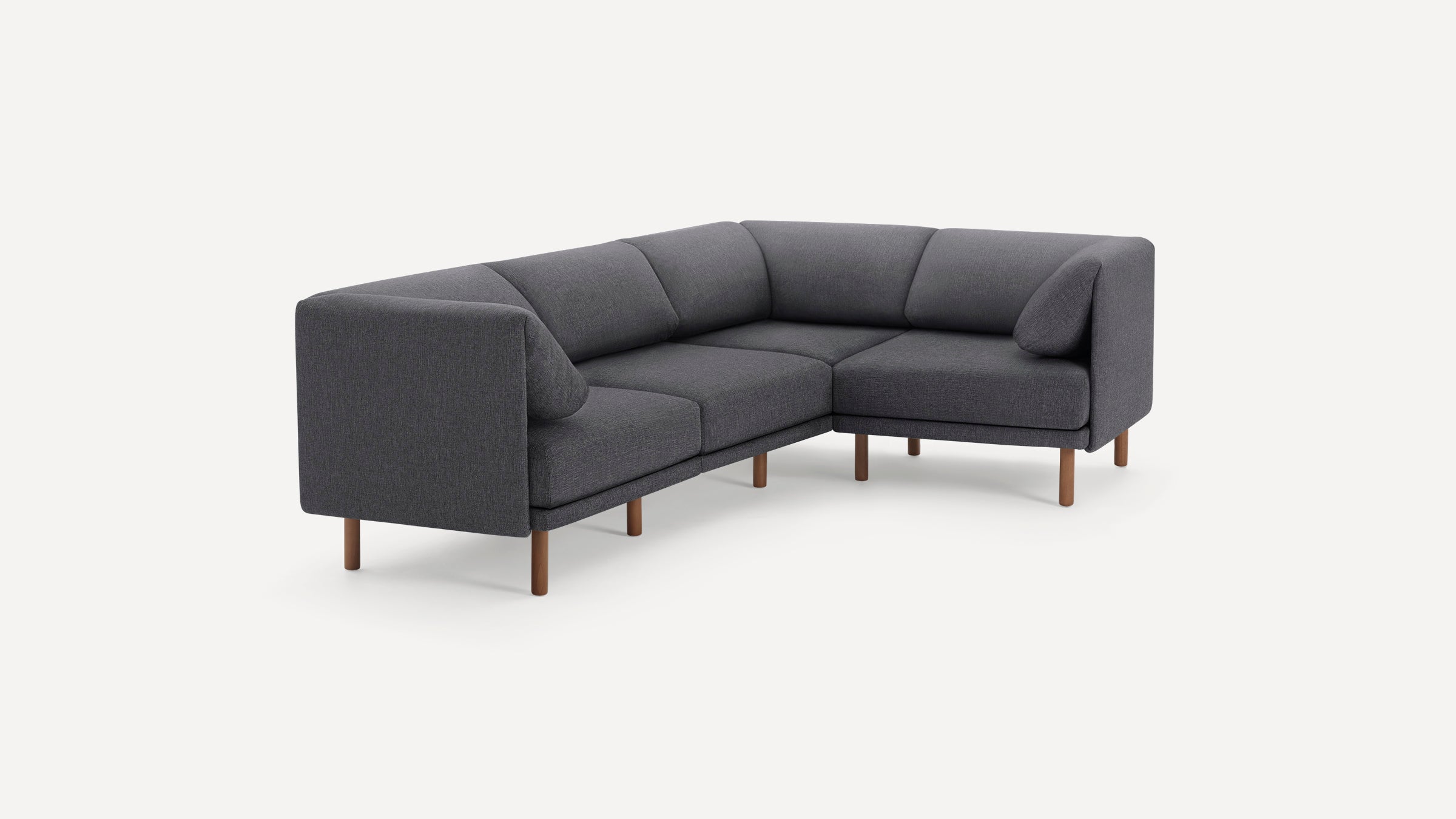 Modern dark gray fabric sectional sofa with wooden legs, featuring clean lines and two angled backrest cushions.