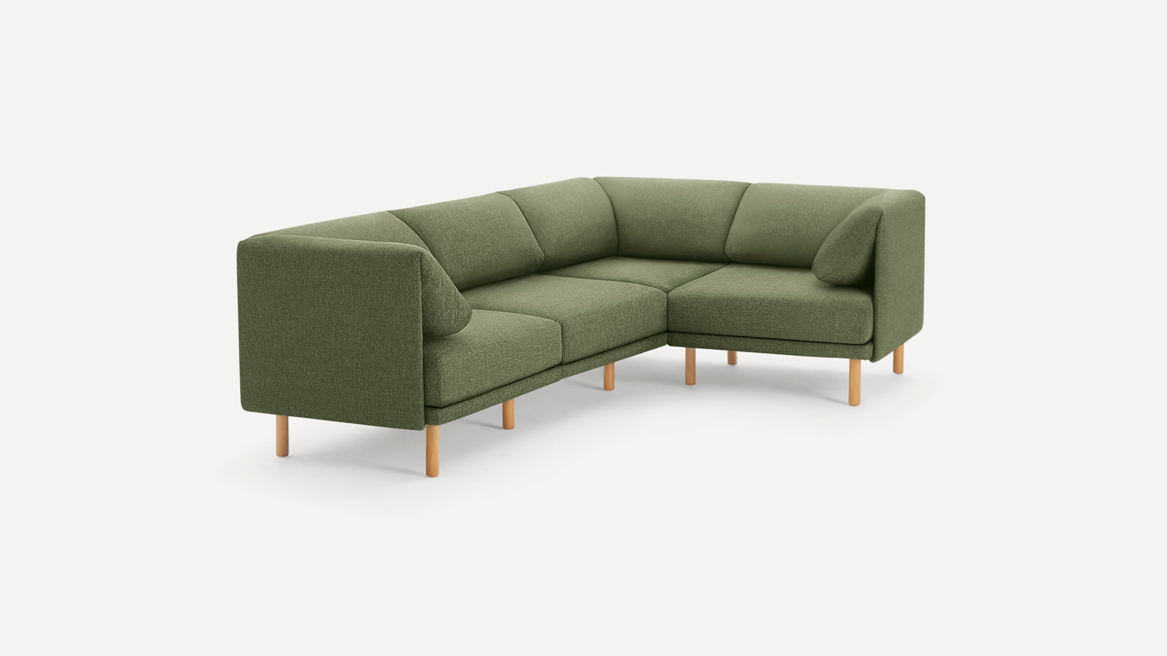 Green fabric L-shaped sectional sofa with wooden legs and modern, minimalist design on white background.