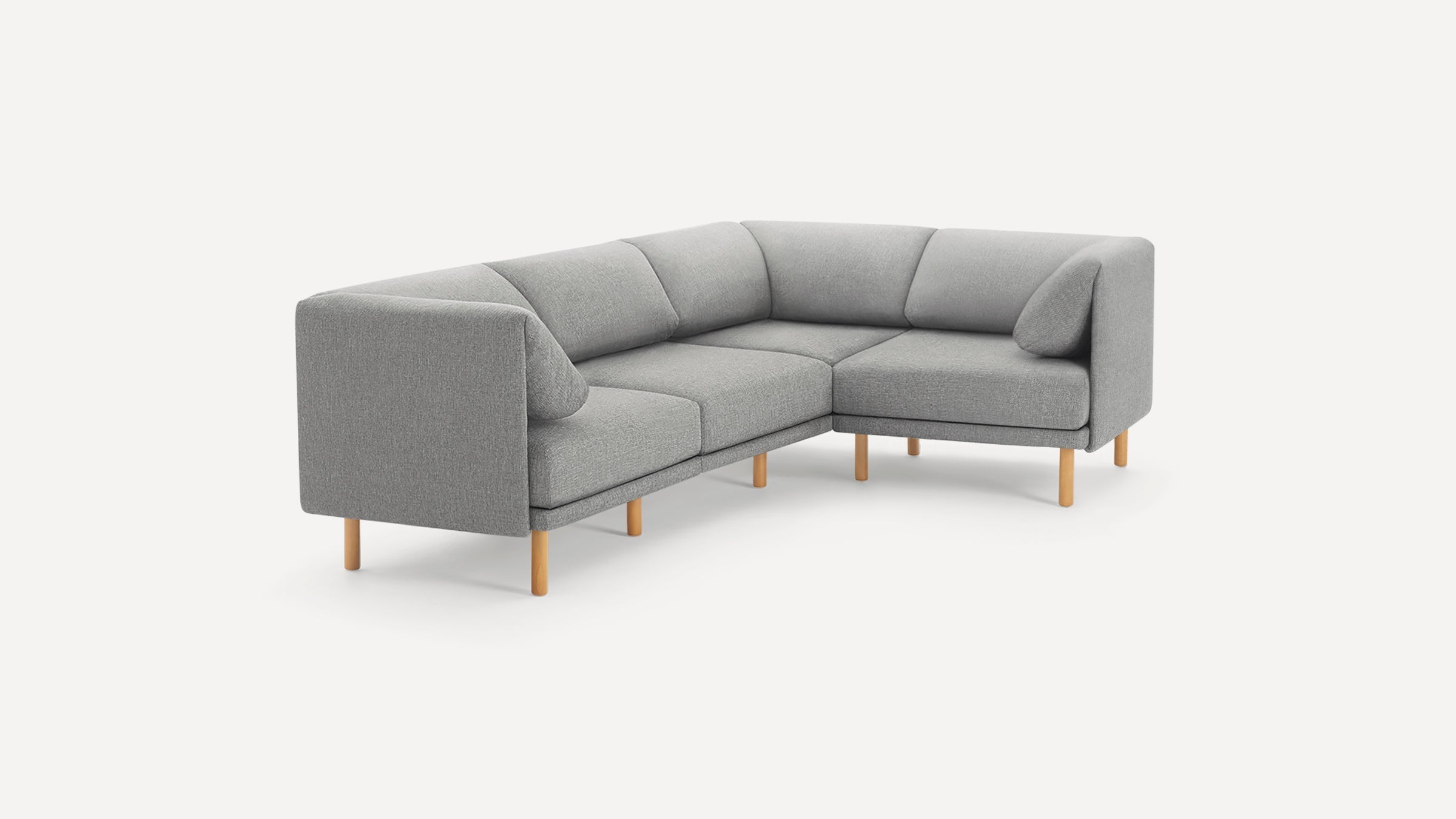 Modern L-shaped gray fabric sectional sofa with wooden legs, featuring clean lines and a minimalist design.