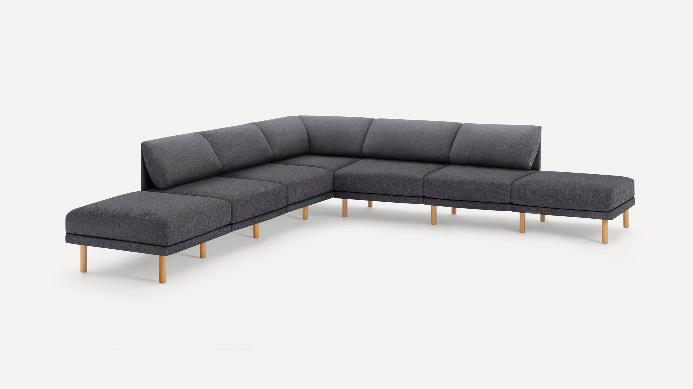 Modern L-shaped sectional sofa with dark gray upholstery and light wooden legs, featuring cushioned seats and backrests.