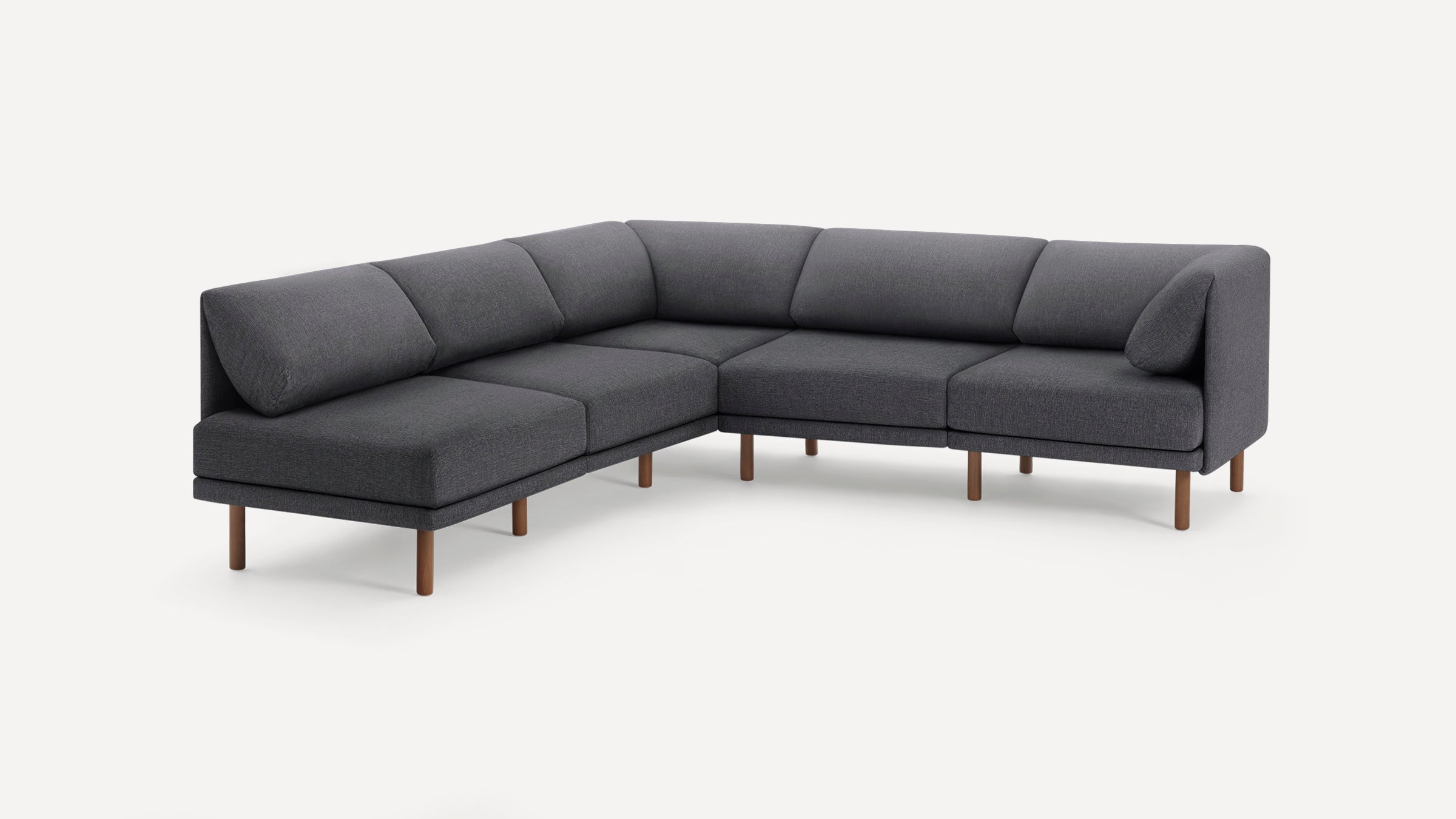 Dark gray fabric L-shaped sectional sofa with wooden legs and cushioned backrests on a plain white background.
