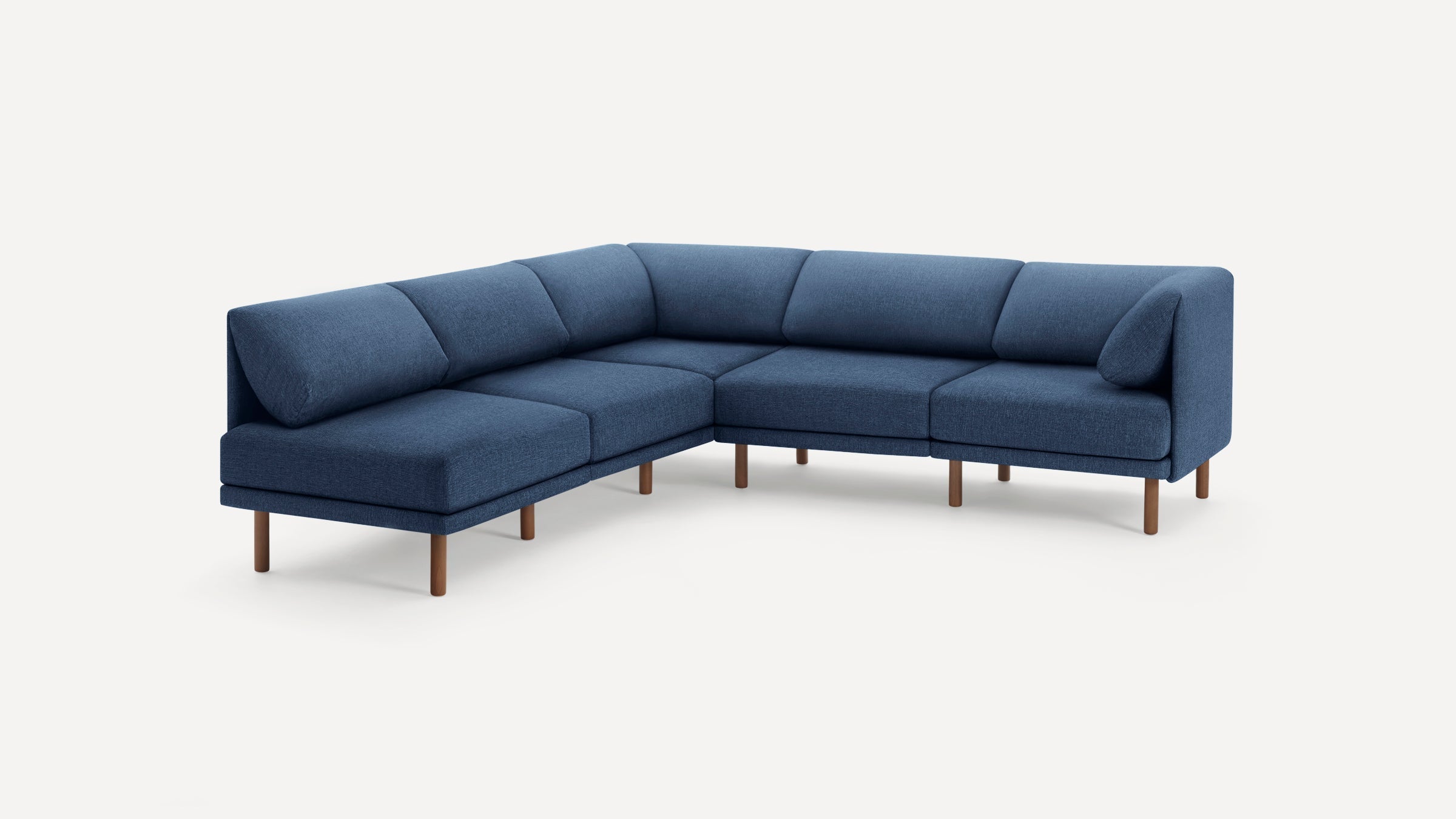 Modern L-shaped sectional sofa with deep blue fabric upholstery and wooden legs, featuring clean lines and angled back cushions.