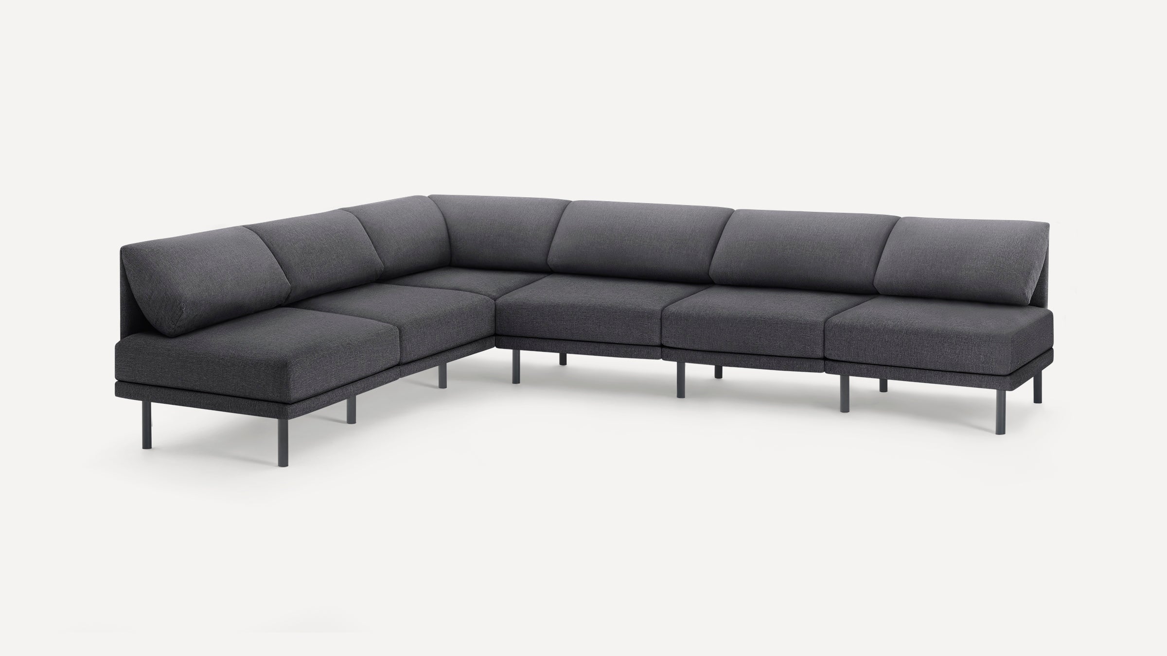Modern dark gray L-shaped sectional sofa with cushioned seats, angled backrests, and slim black legs on a white background.