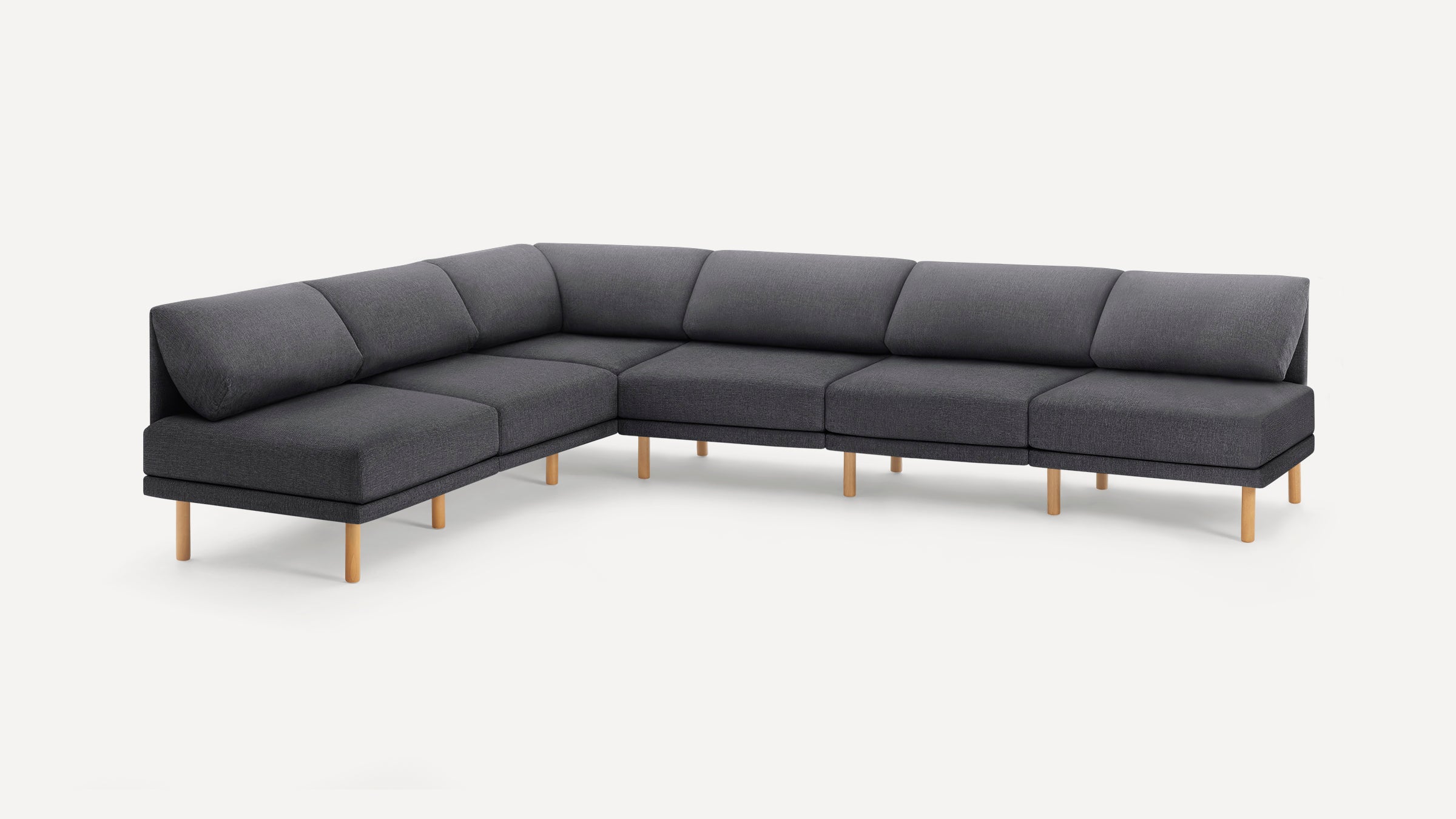 Modern L-shaped sectional sofa with dark gray fabric upholstery and light wood legs, offering spacious comfortable seating.