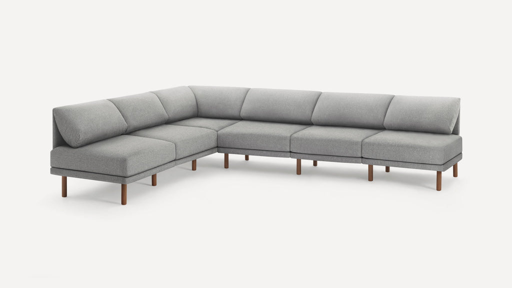 Large modern gray sectional sofa with fabric upholstery and wooden legs, featuring a low back and plush cushions.