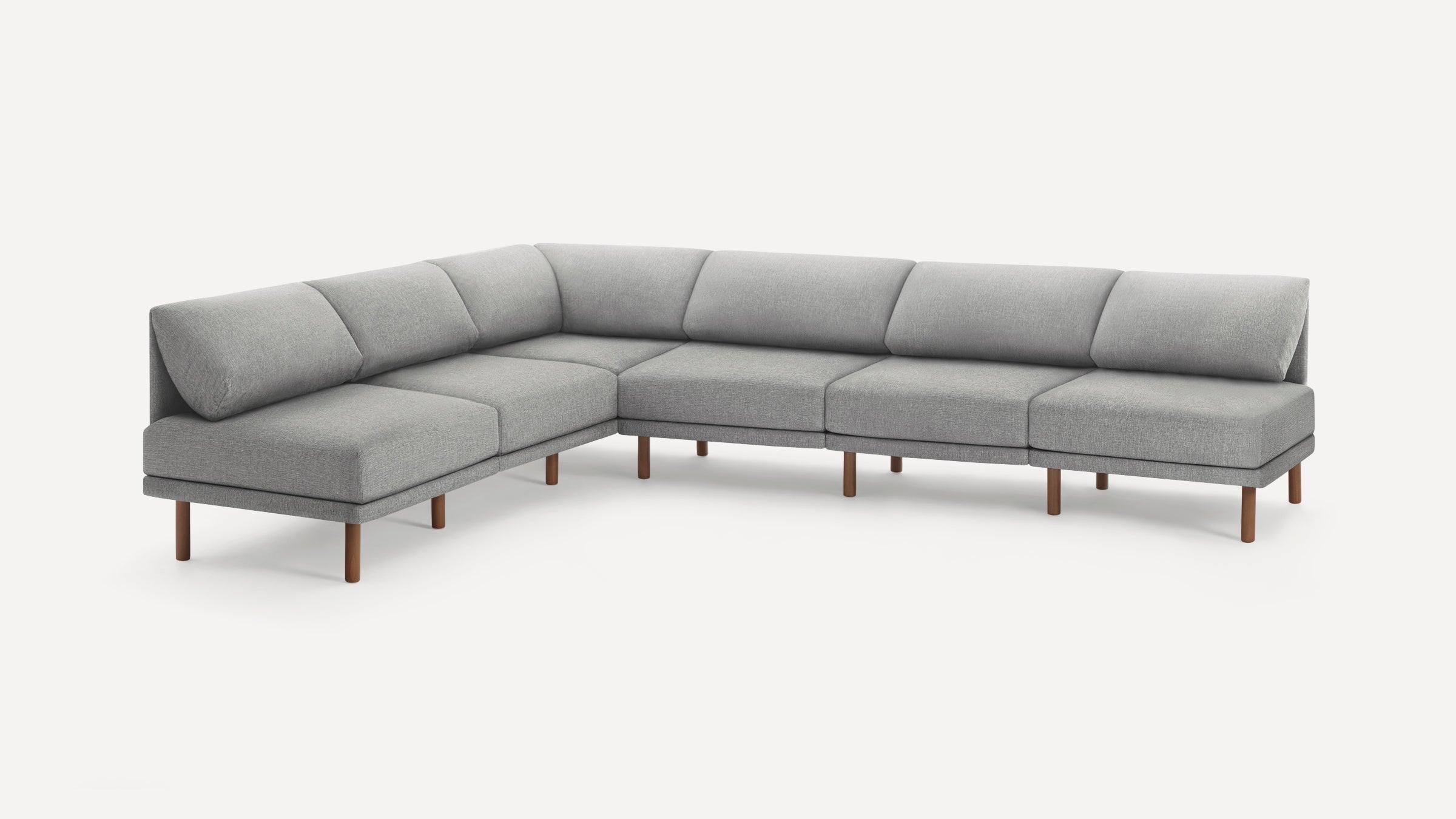 Large modern gray sectional sofa with fabric upholstery and wooden legs, featuring a low back and plush cushions.