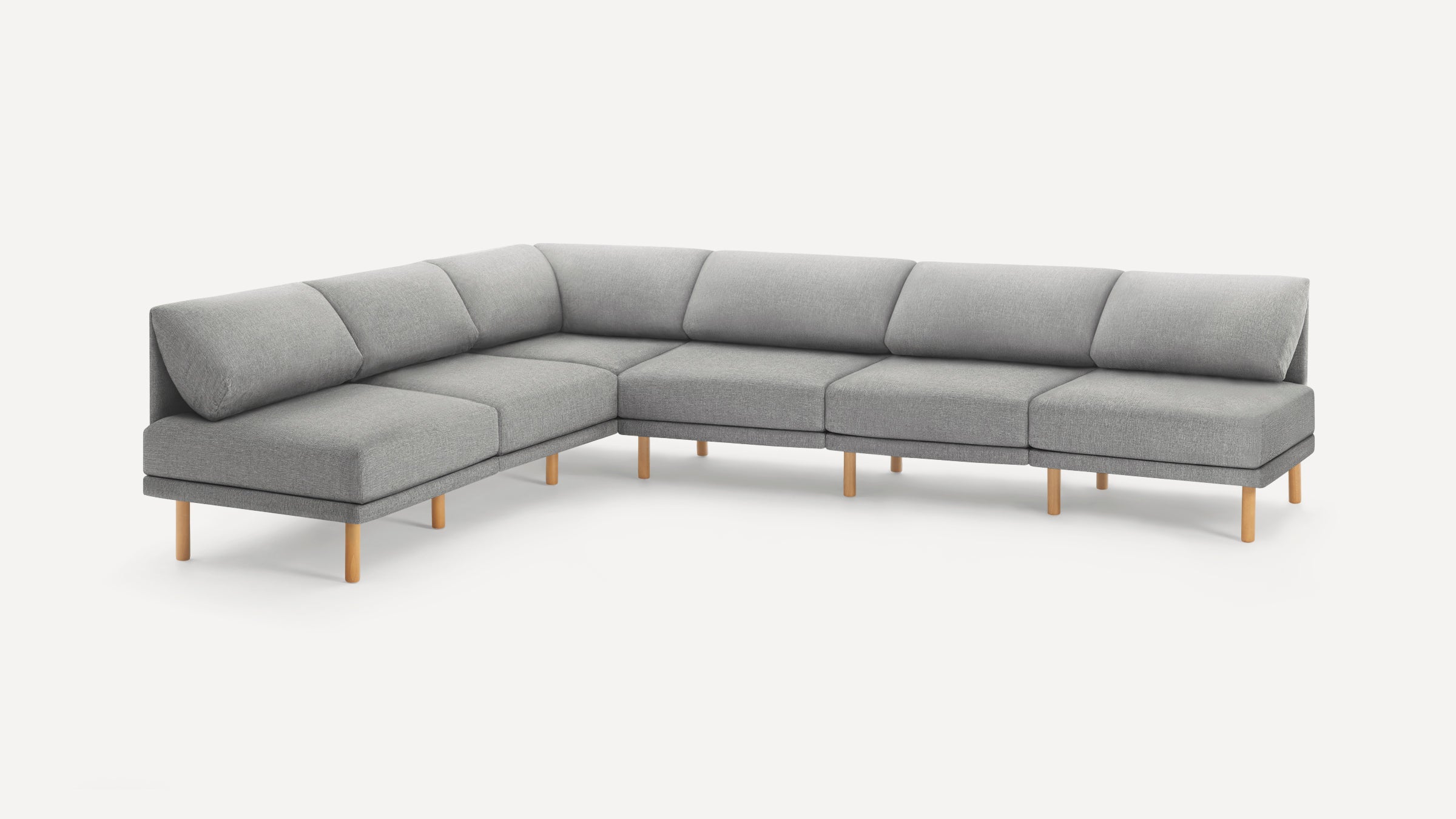 Modern L-shaped sectional sofa with light gray fabric upholstery and wooden legs, featuring clean lines and angled back cushions.