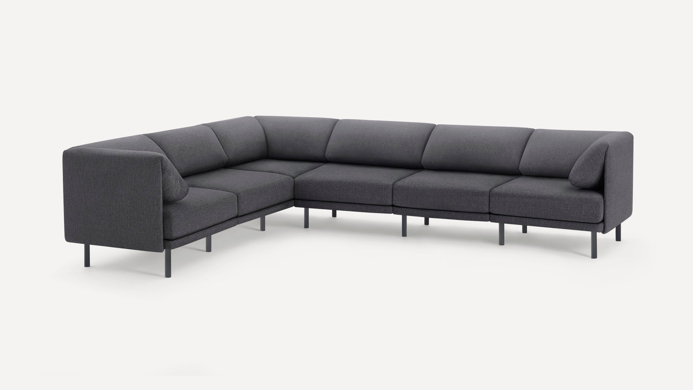 Dark gray modern L-shaped sectional sofa with slim metal legs and angled cushions on a white background.