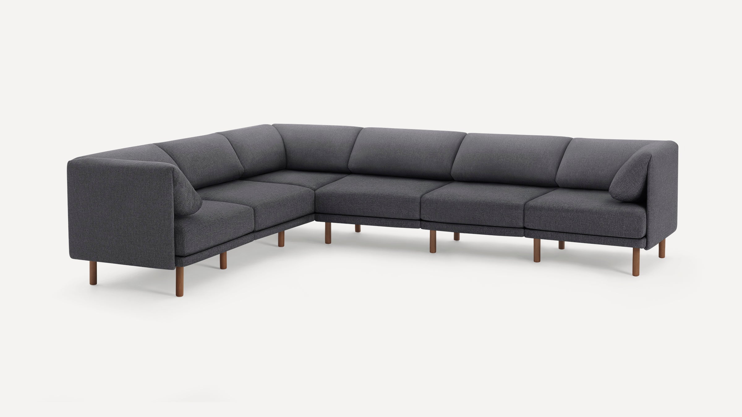 Modern dark gray fabric sectional sofa with wooden legs, designed for spacious corner seating and minimalist style.