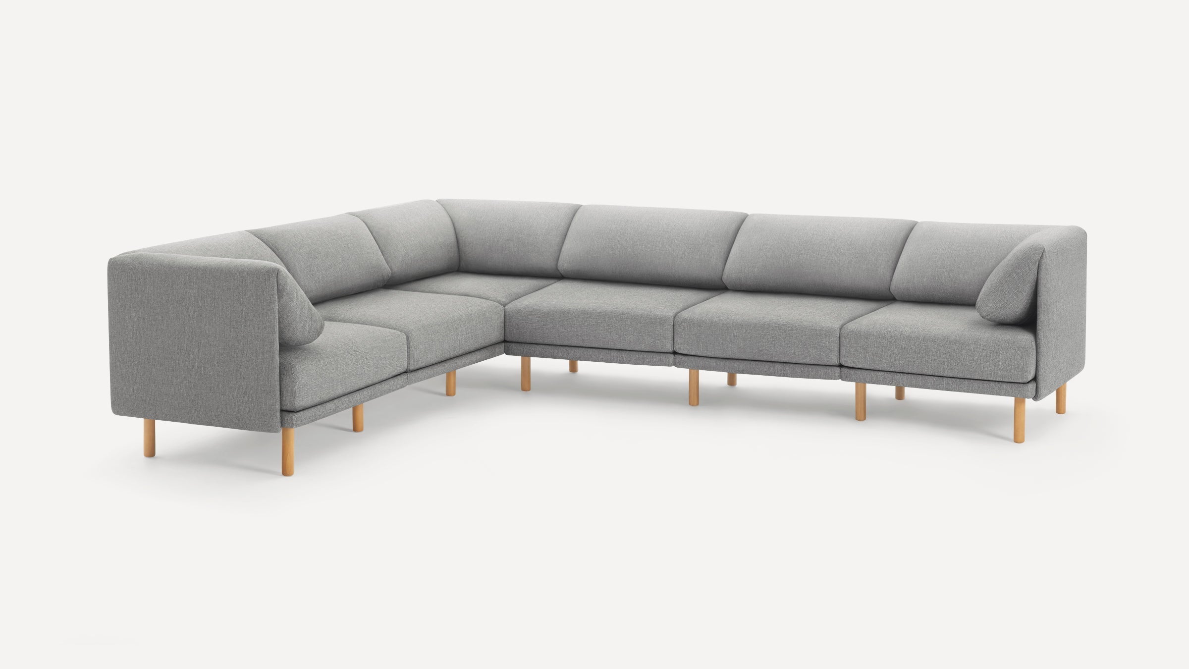 Modern L-shaped sectional sofa with light gray fabric upholstery, cushioned seats, and wooden legs on a white background.