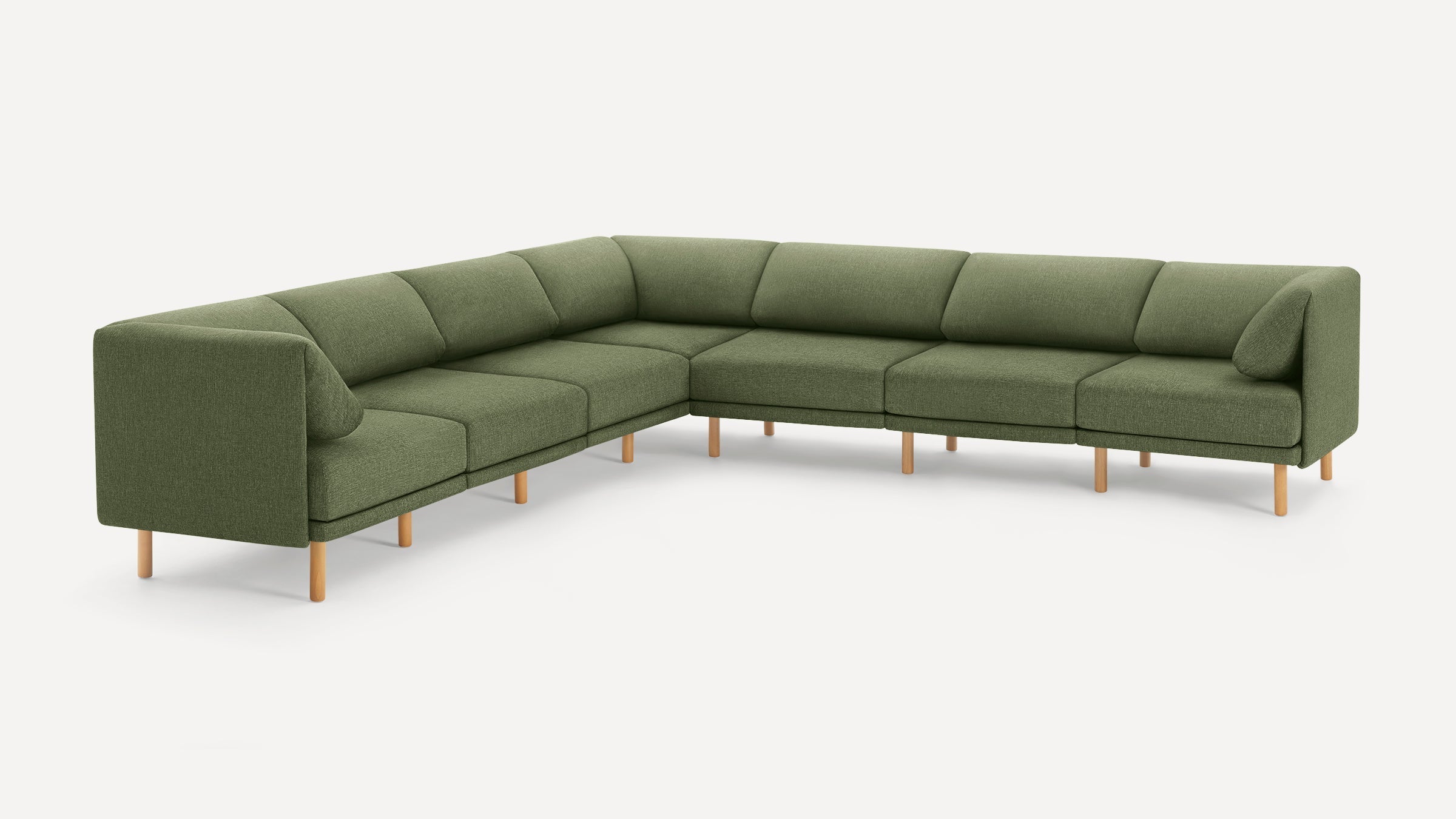 Large modern L-shaped sectional sofa with olive green fabric upholstery and light wooden legs on white background.