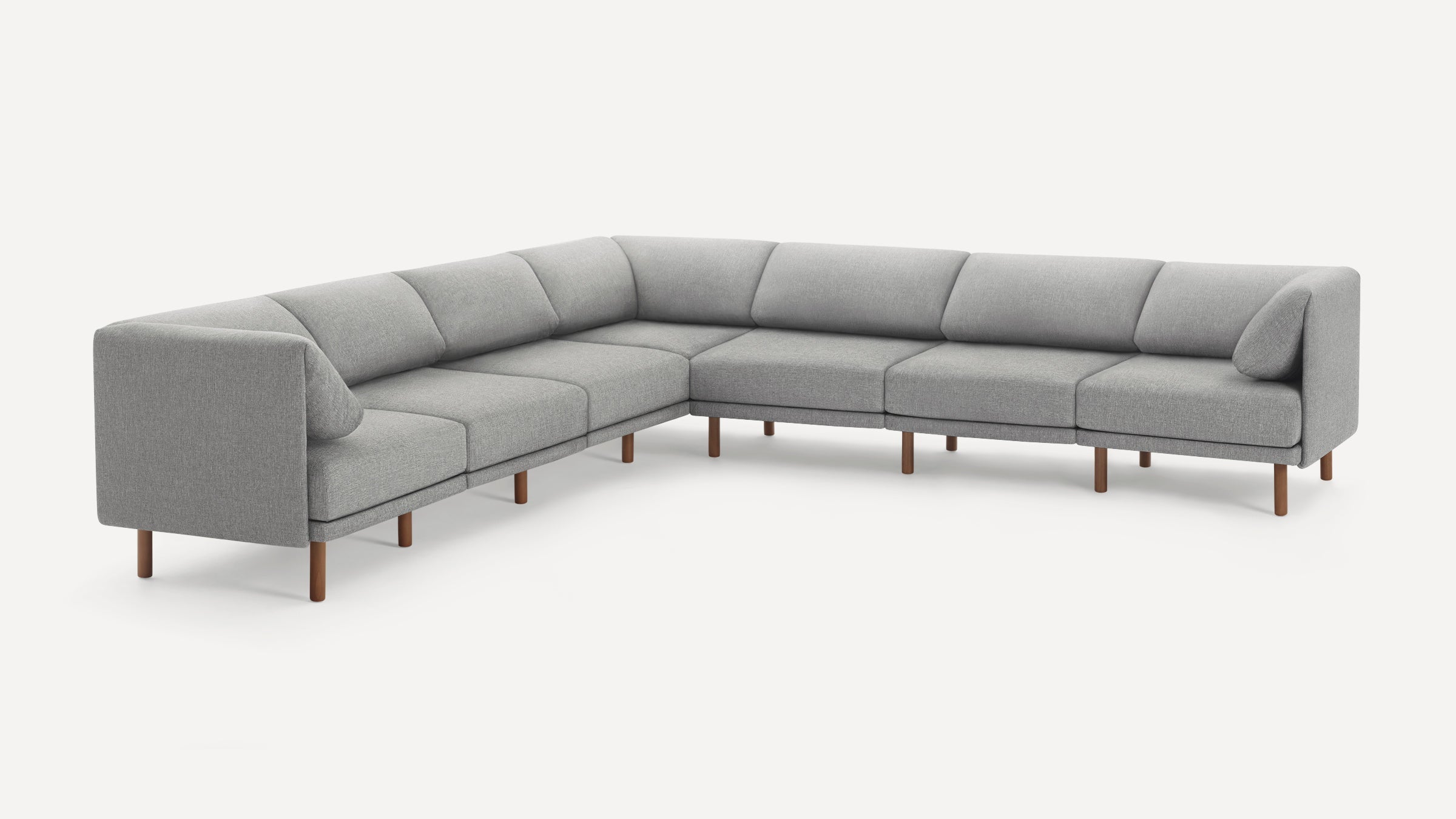 Modern large gray fabric sectional sofa with wooden legs, clean lines, and attached back cushions on a white background.