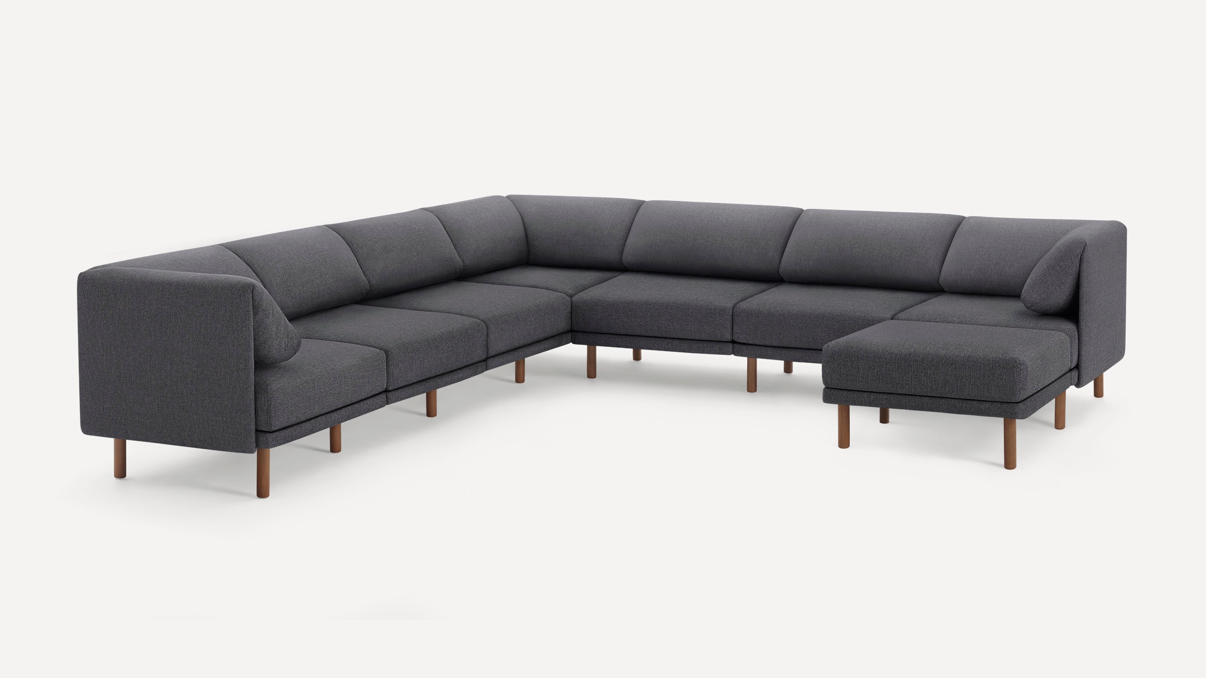 Modern dark gray fabric sectional sofa with wooden legs and minimalist design, featuring a right-sided chaise lounge.