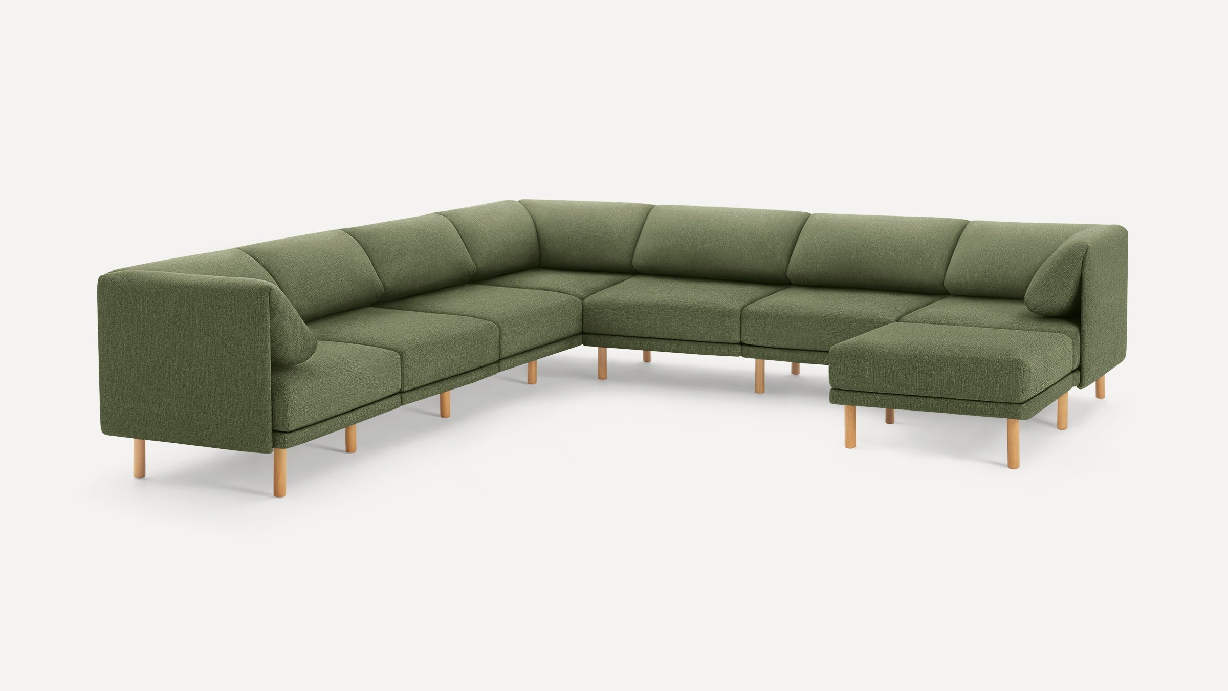 Large green sectional sofa with wooden legs, featuring L-shaped design and straight, minimalistic lines.