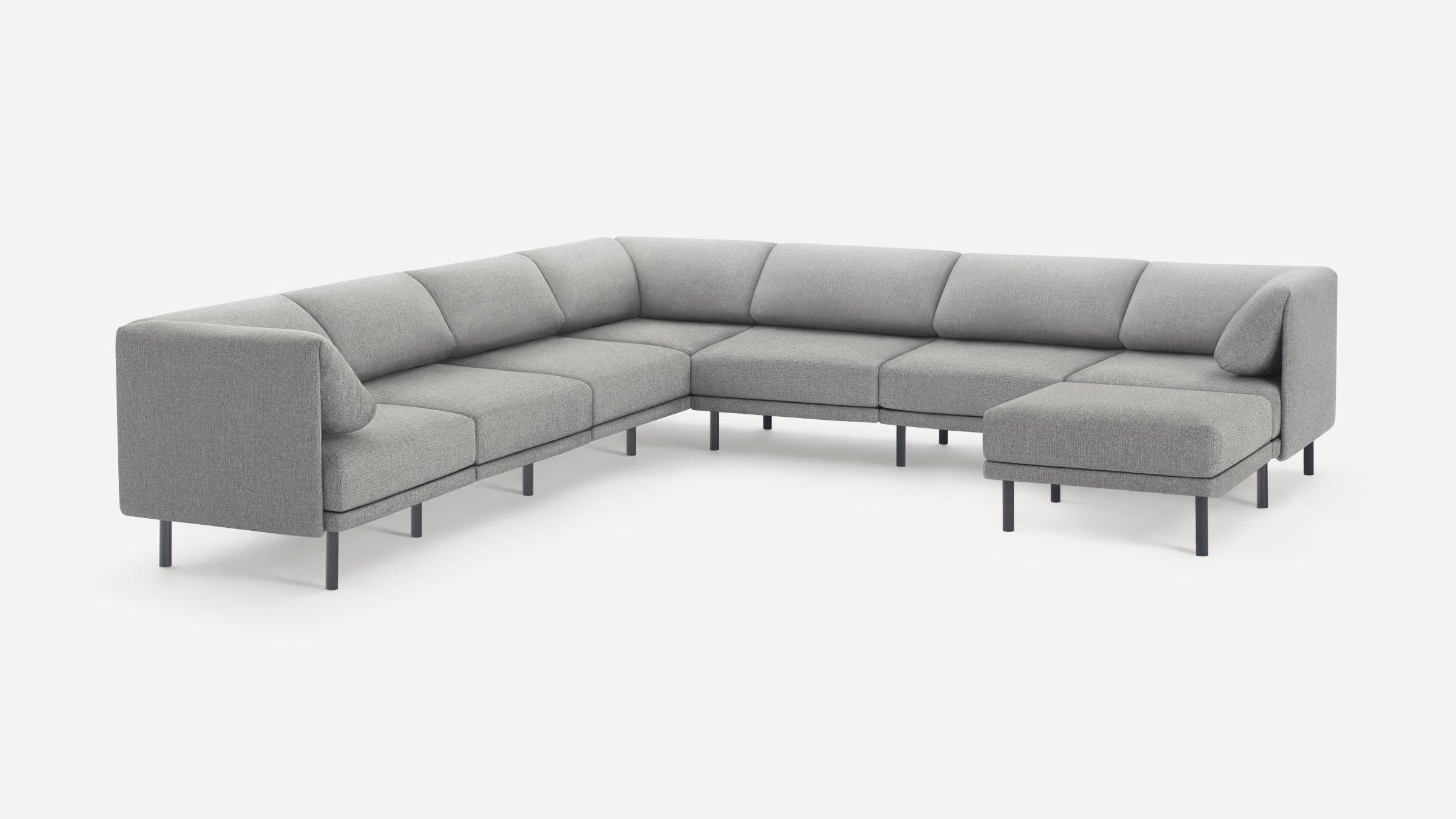Modern gray fabric sectional sofa with L-shape design, featuring slim black metal legs and plush back cushions.