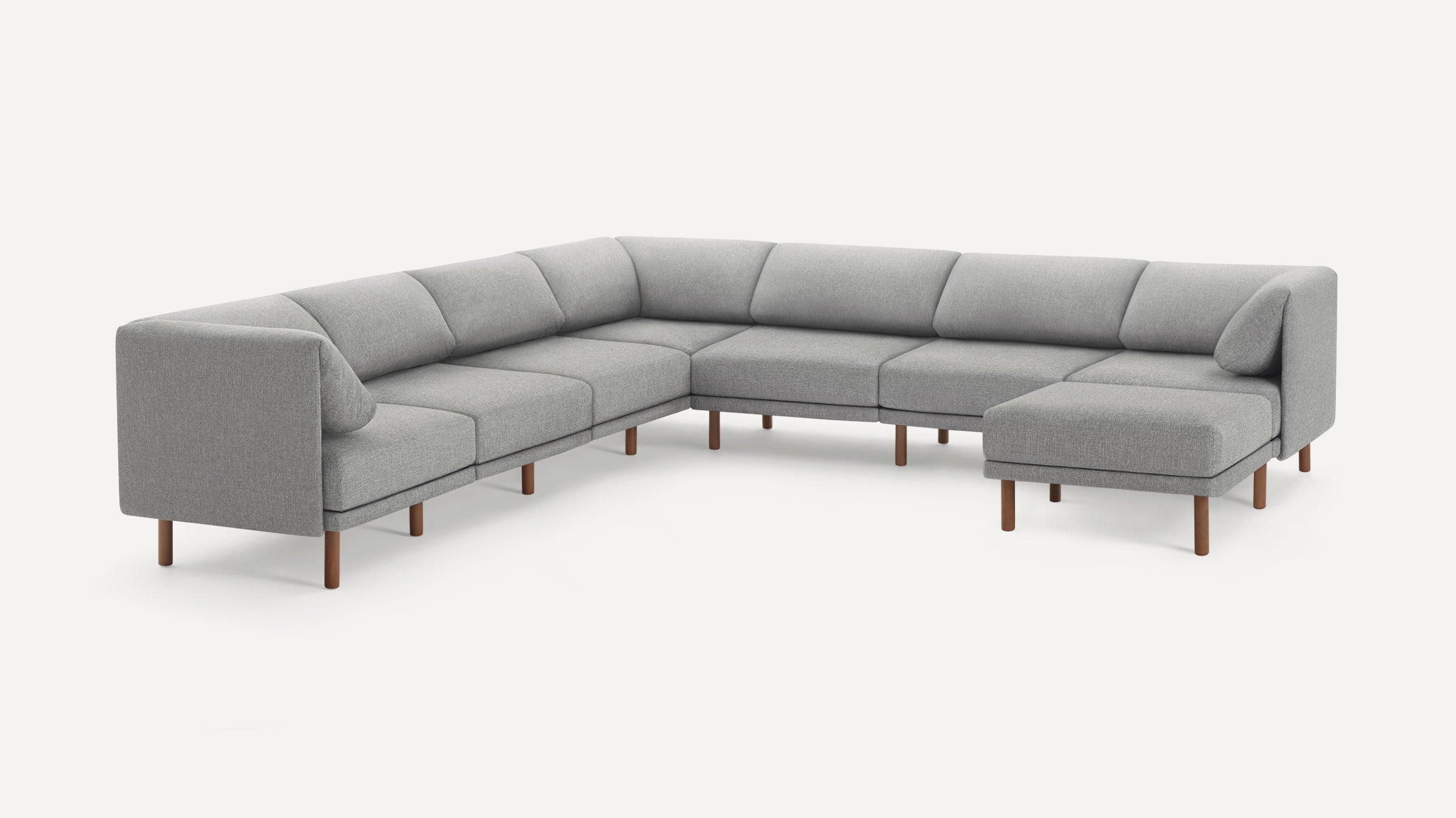 Modern large L-shaped sectional sofa with light gray fabric upholstery and wooden legs, designed for spacious living rooms.
