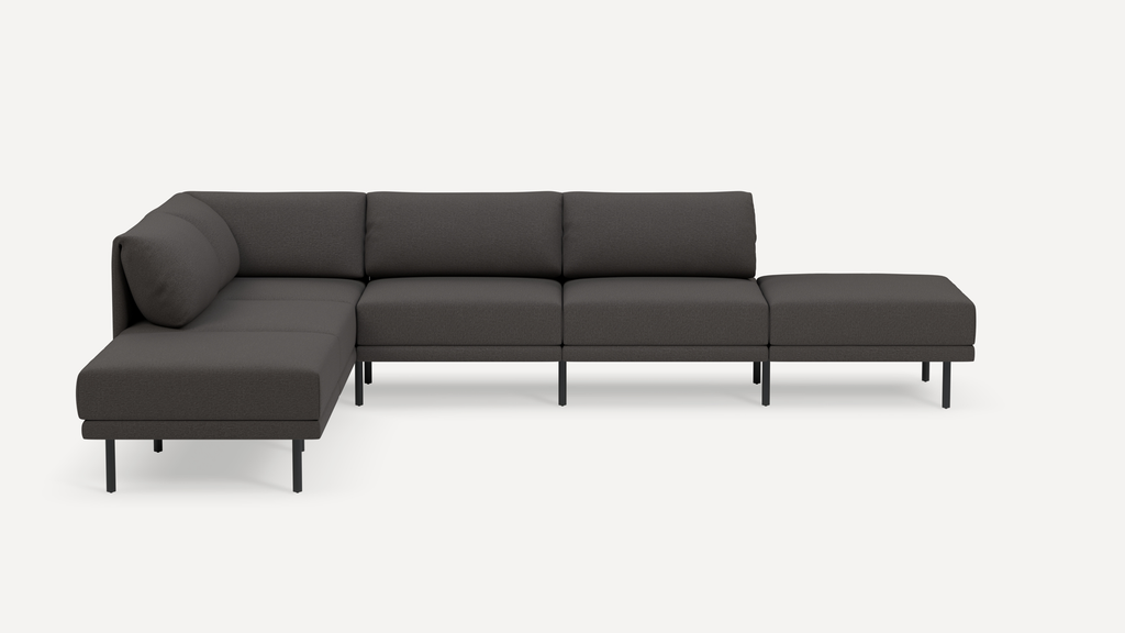 Modern dark gray L-shaped sectional sofa with minimalist black metal legs and plush cushions on a white background.