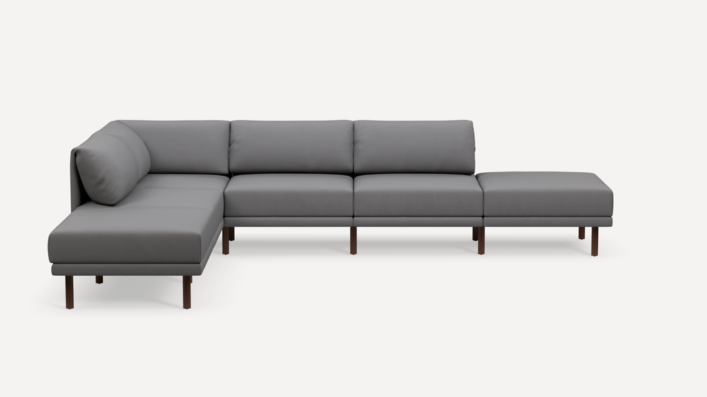 Modern L-shaped sectional sofa in gray fabric with wooden legs, featuring clean lines and cushioned backrests and seats.