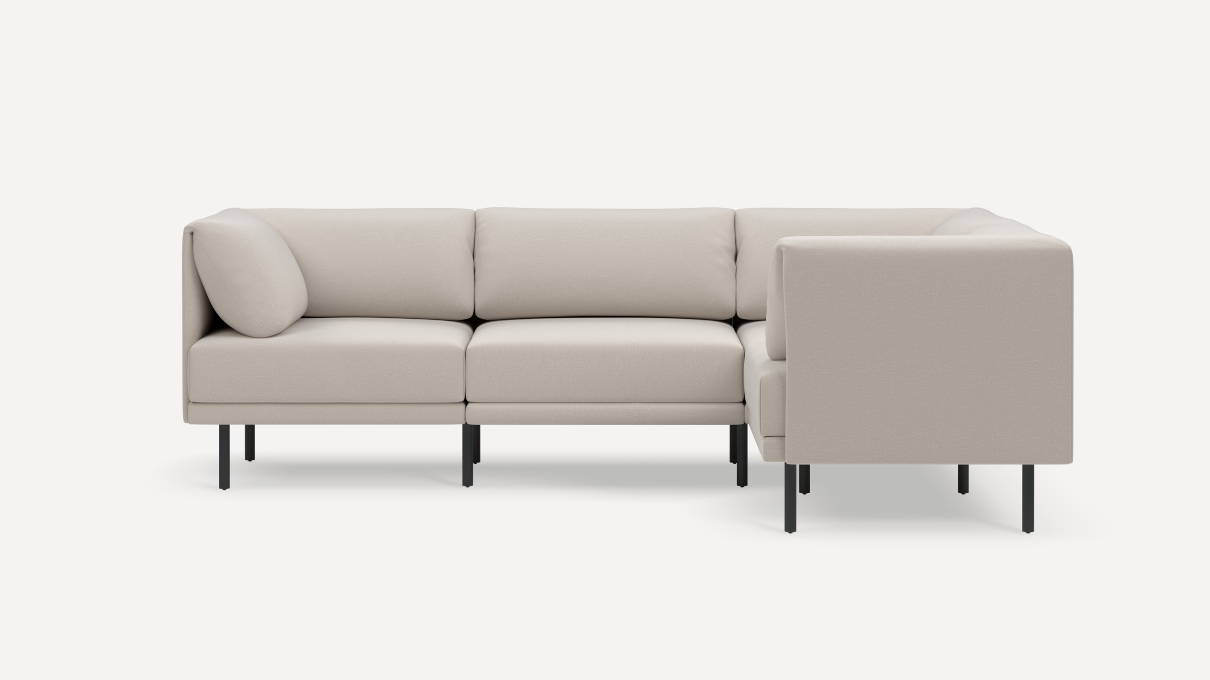 Modern L-shaped beige sectional sofa with black metal legs, featuring cushioned seats and backrests for comfortable seating.