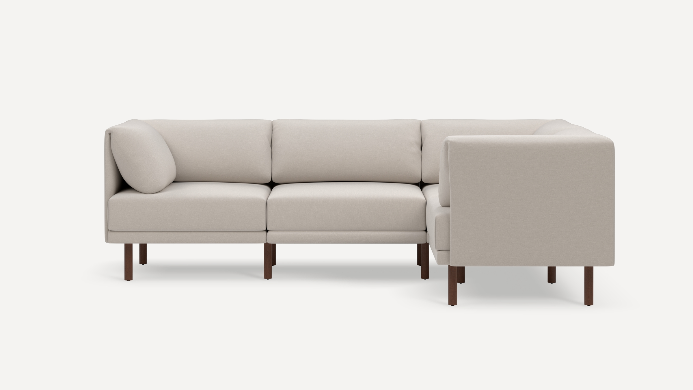 Beige L-shaped sectional sofa with clean lines, plush cushions, and wooden legs, shown against a white background.