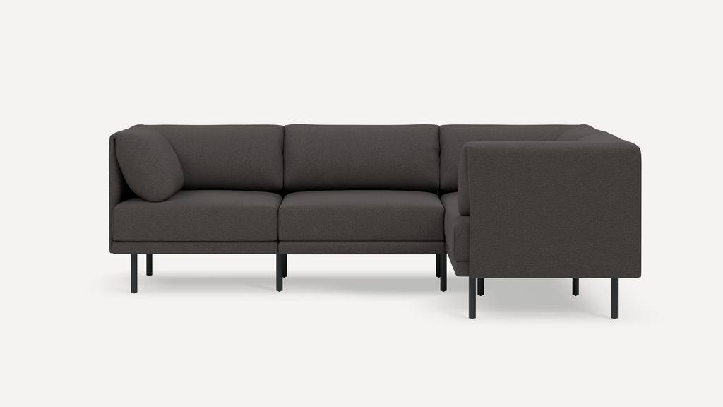 Modern dark gray L-shaped sectional sofa with clean lines, slim black legs, and plush cushions against white background.
