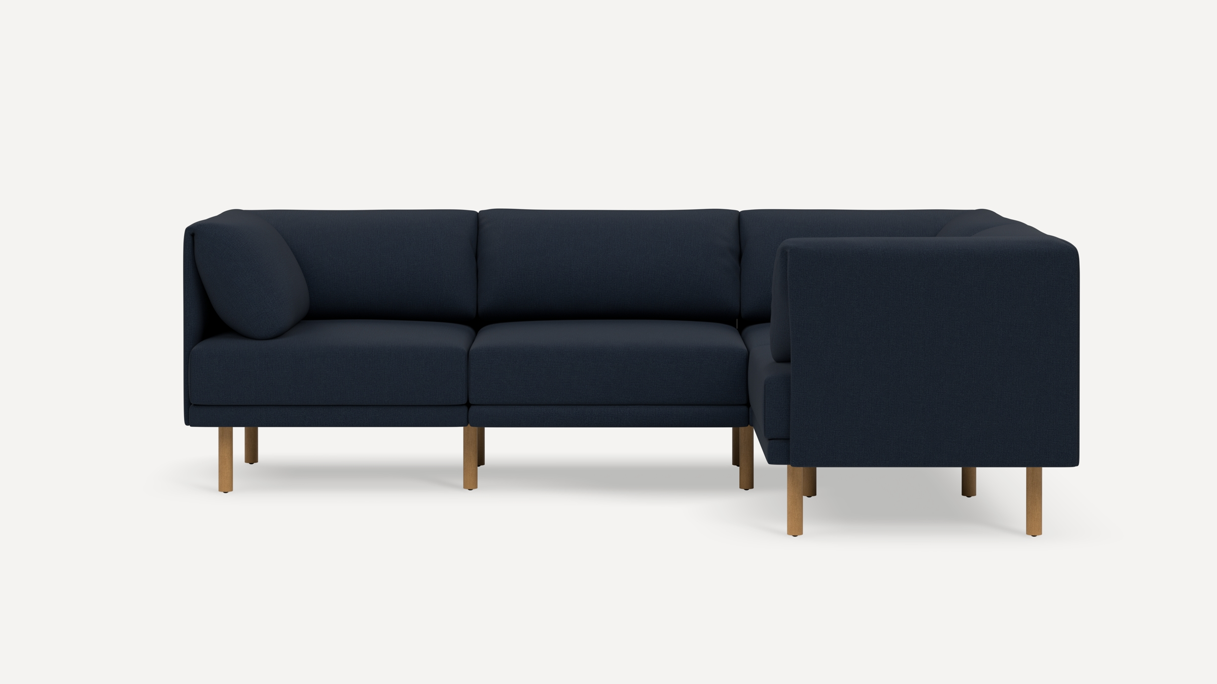 Dark blue fabric L-shaped sectional sofa with wooden legs against a plain white background.