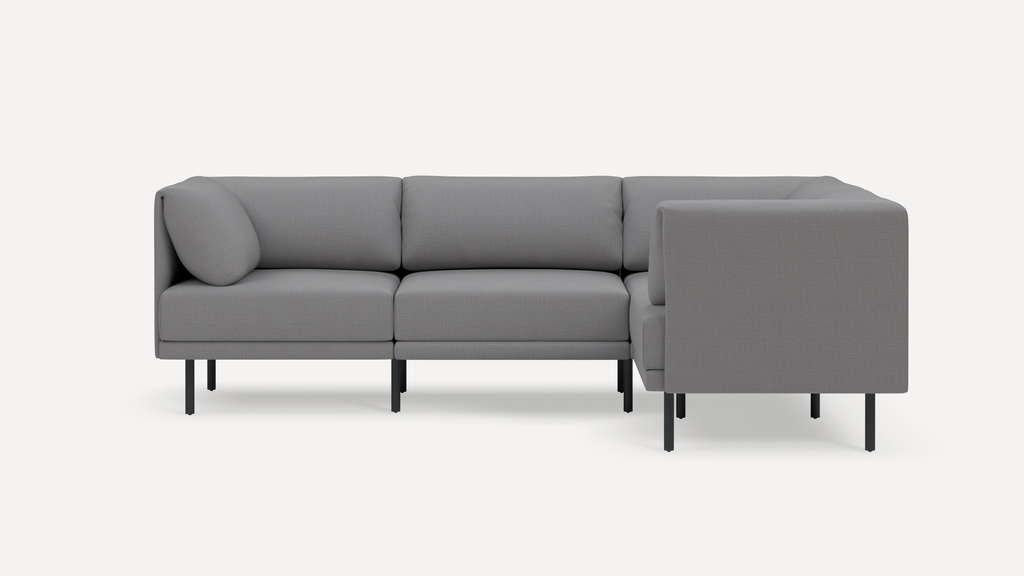 Modern gray L-shaped sectional sofa with cushioned seats, straight armrests, and black metal legs on white background.
