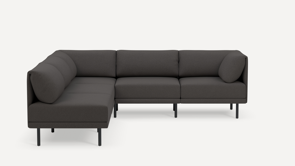 Modern dark gray L-shaped sectional sofa with cushioned backrests and slim black metal legs, minimalist design.