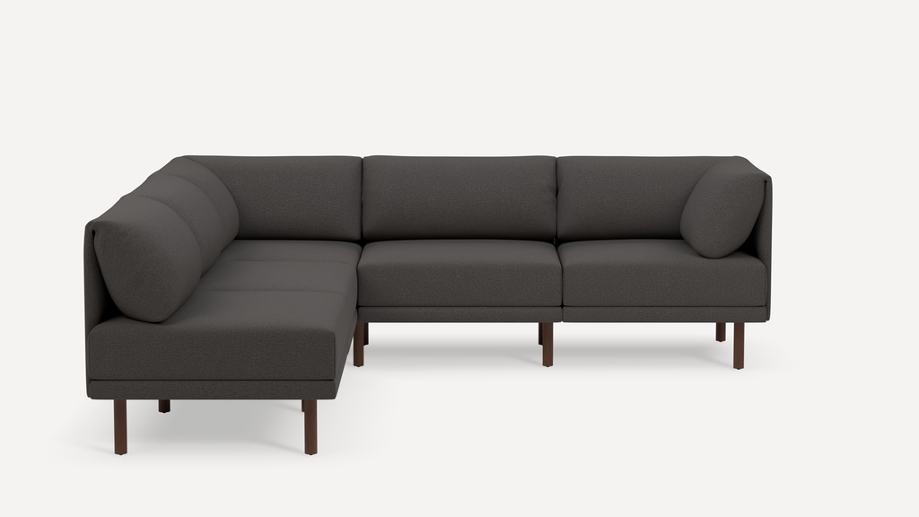 Modern L-shaped dark gray fabric sectional sofa with clean lines and wooden legs, featuring cushioned back and seat.