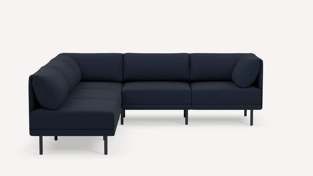 Modern L-shaped sectional sofa in dark navy fabric with sleek black metal legs and block cushions.