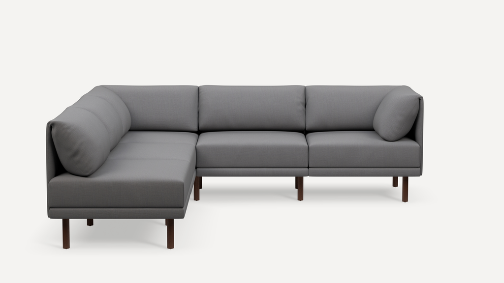 Modern L-shaped sectional sofa with gray fabric upholstery, cushion backrests, and wooden legs on a white background.