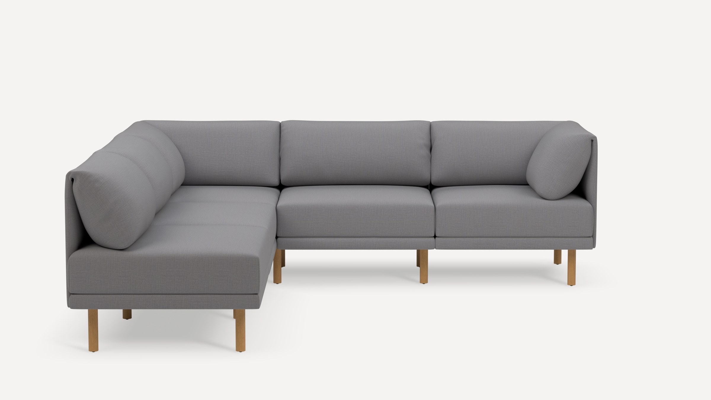 Modern L-shaped sectional sofa with light gray fabric upholstery and wooden legs, featuring cushioned backrests and armrests.