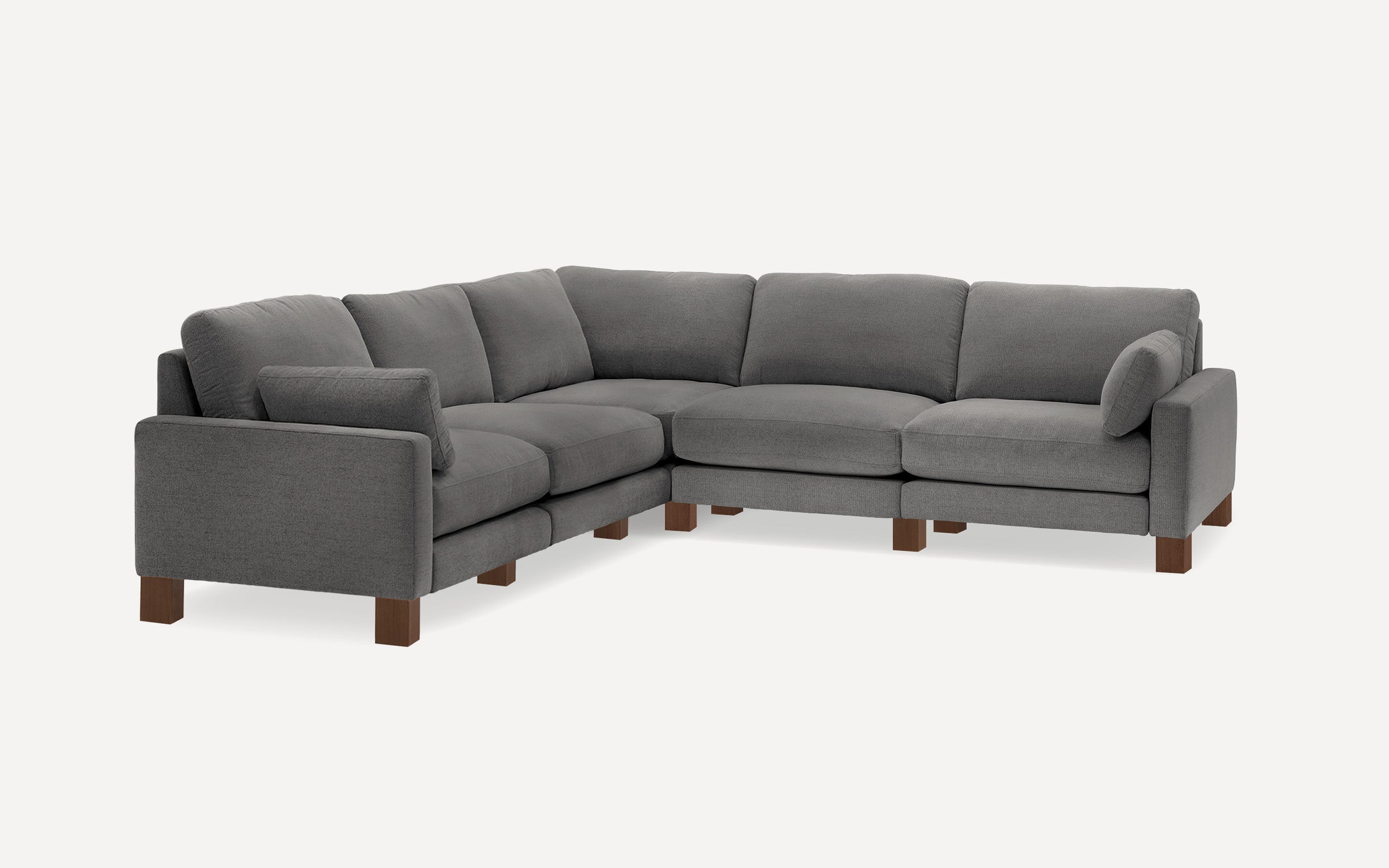L-shaped sectional sofa with dark gray fabric upholstery, plush cushions, wooden legs, and a modern minimalist design.