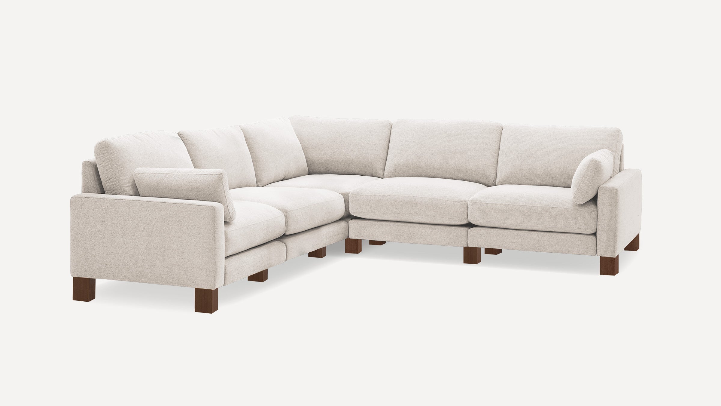 Light beige fabric sectional sofa with wooden legs, cushioned seats, and backrests, arranged in an L-shape design.