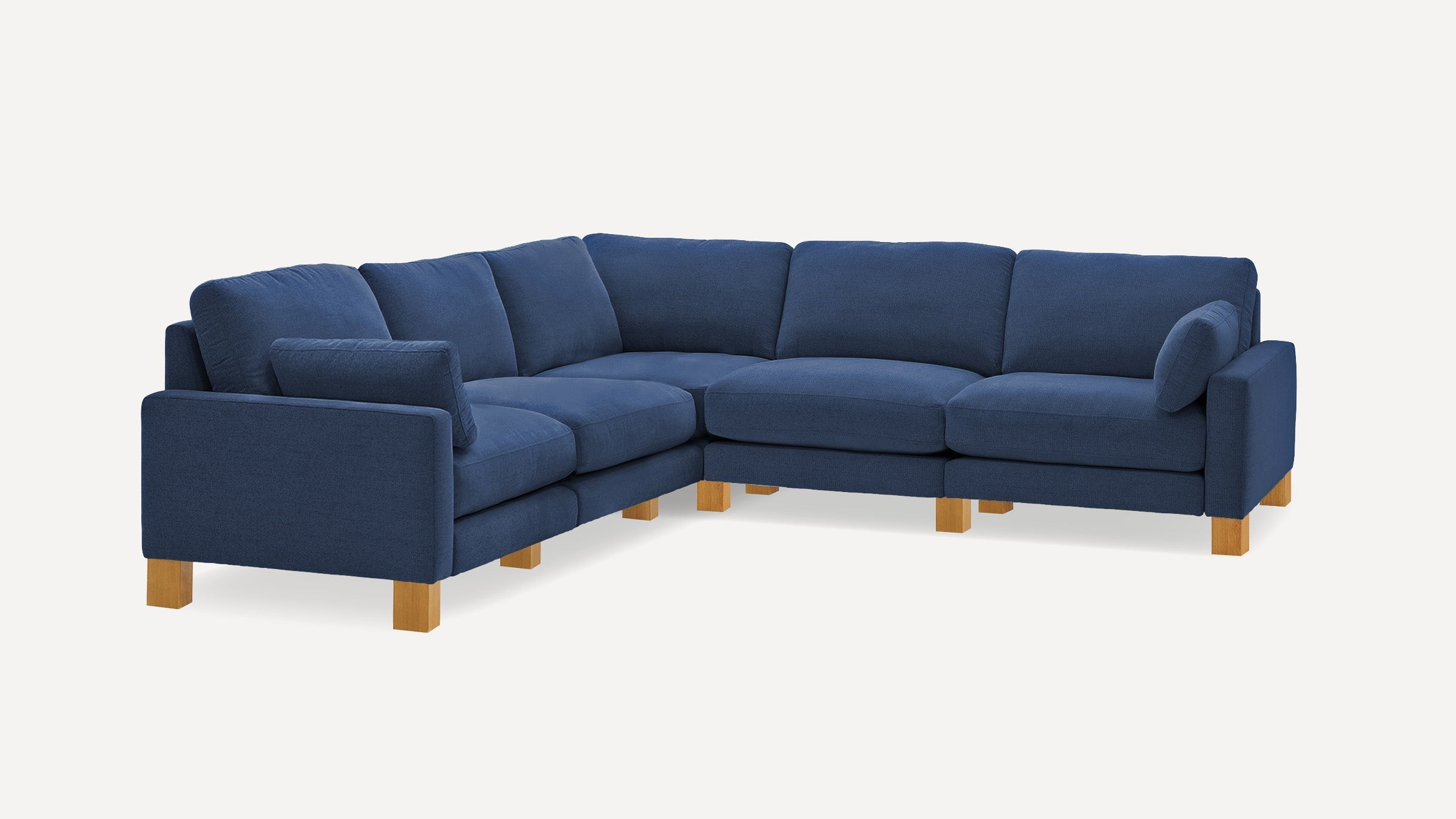 Navy blue L-shaped sectional sofa with plush cushions and light wooden block legs, designed for corner placement and comfort.