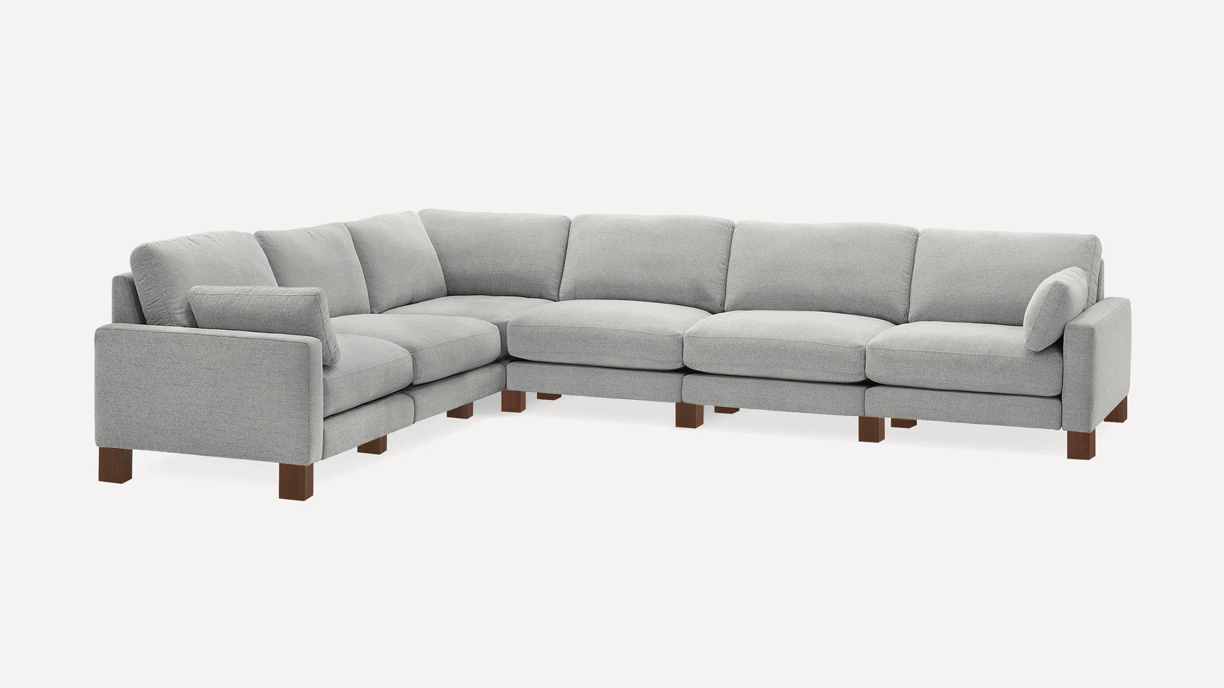 Modern light gray fabric sectional sofa with wooden block legs, cushioned back and seat, and angled corner design.