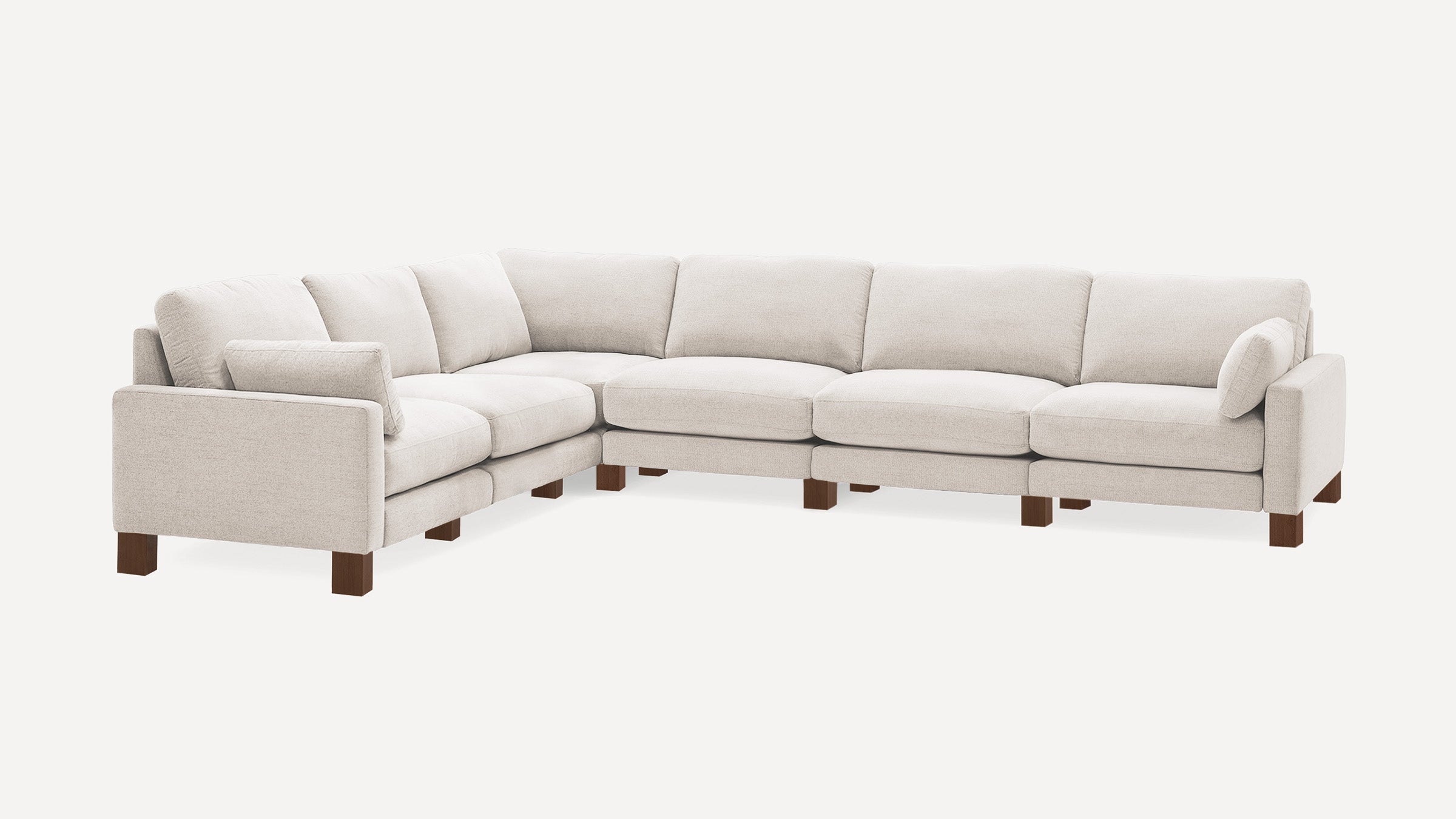 Beige L-shaped sectional sofa with plush cushions and wooden block legs, designed for spacious, modern living rooms.