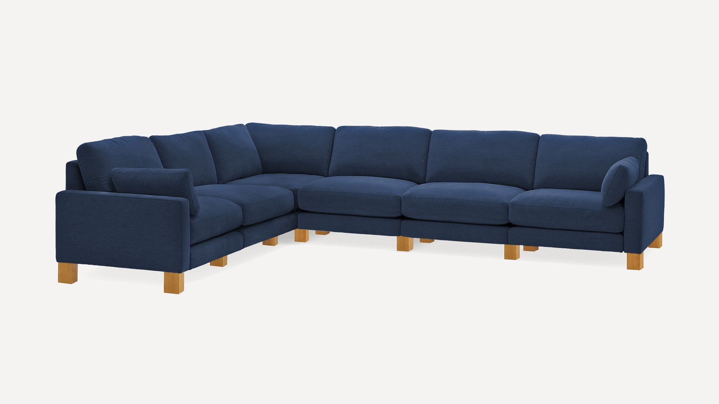 Large navy blue fabric sectional sofa with wooden block legs and multiple cushioned seats and backrests.