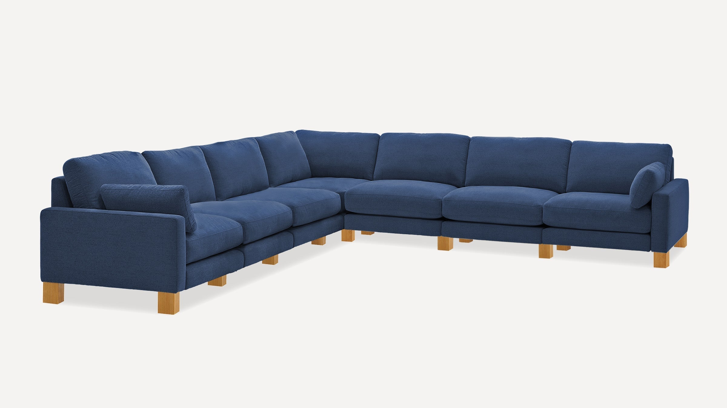 Large modern navy blue fabric sectional sofa with wooden legs, featuring multiple cushions and a corner design.