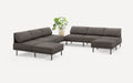 modern dark gray fabric sectional sofa with matching chaise lounge and matching ottoman, featuring a plant in a white background