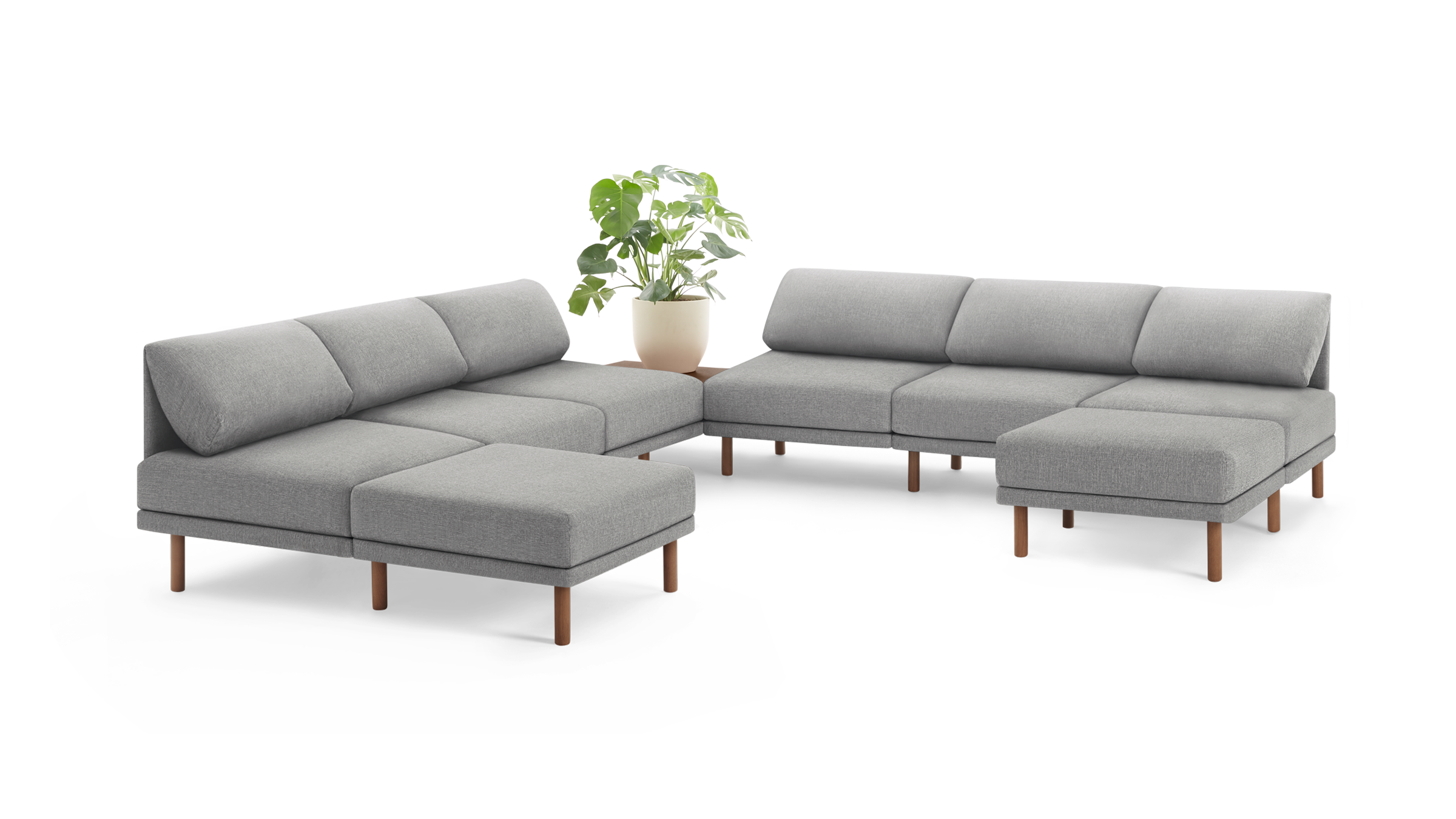 modern light gray fabric sectional sofa with wooden legs and matching ottoman, featuring a clean, minimalist design