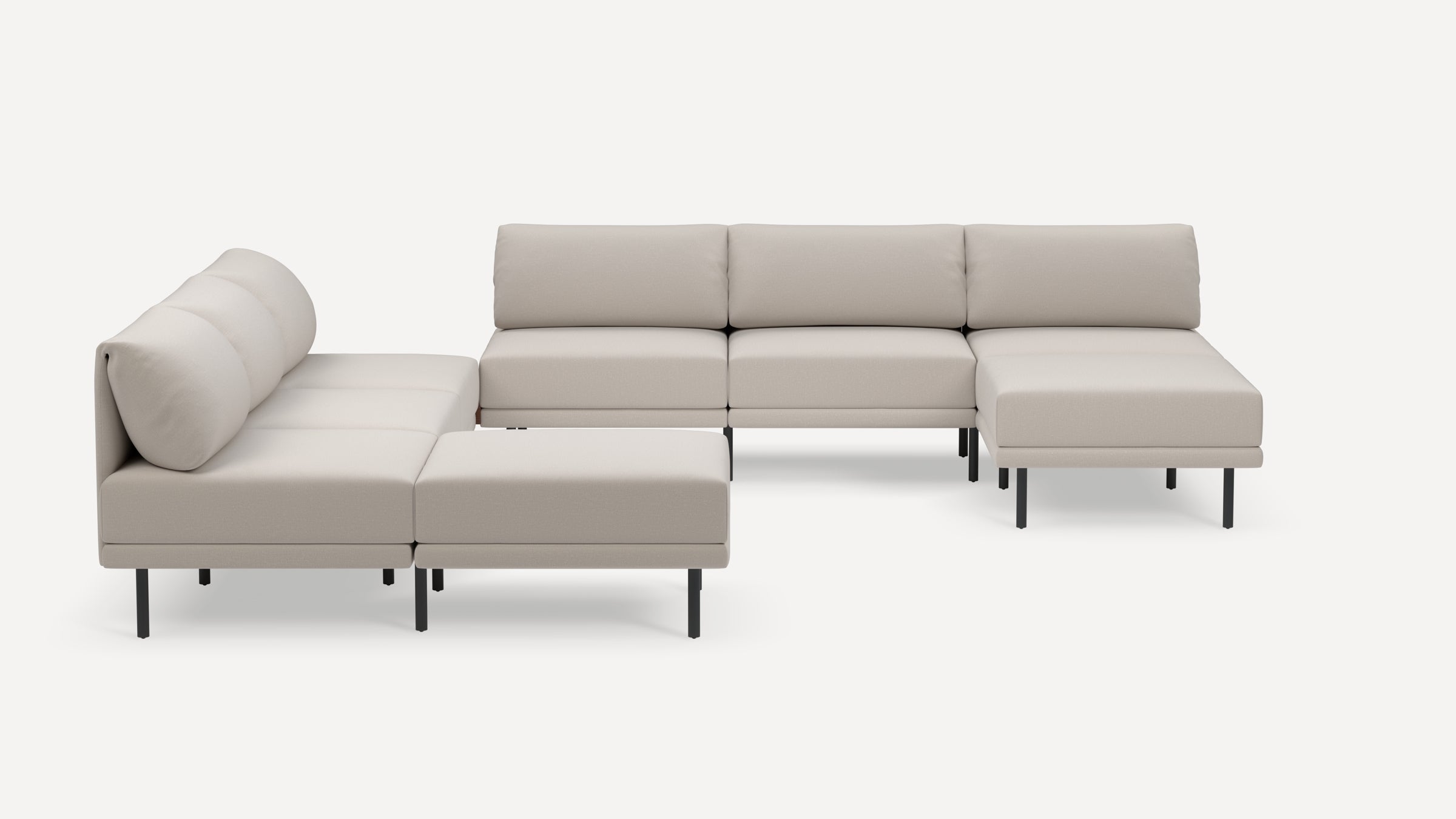 Modern modular beige sectional sofa with cushioned backrests and metal legs, arranged in spacious U-shape on white background.