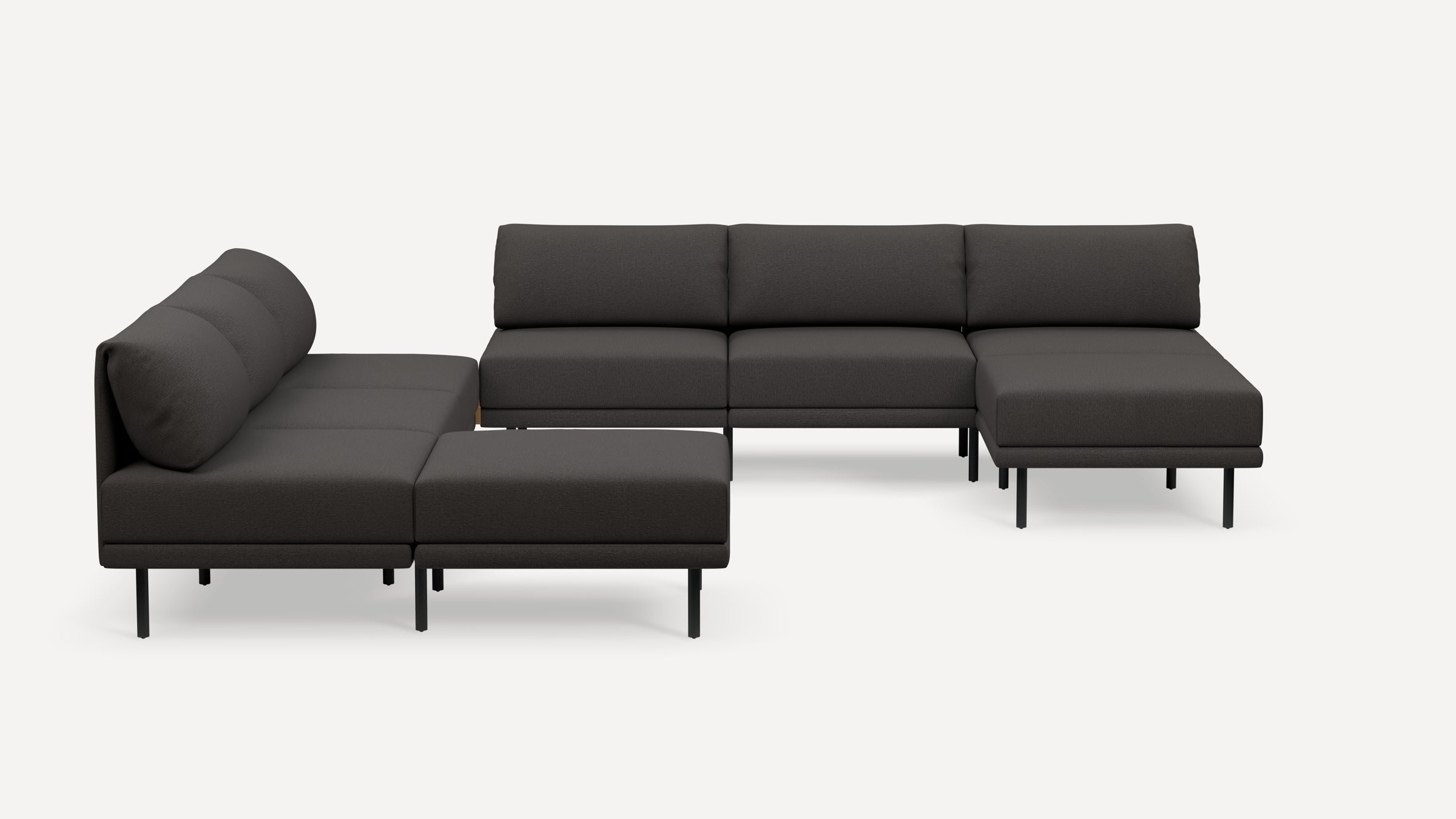 Modern dark gray L-shaped sectional sofa with slim black metal legs, plush cushions, and minimalist design on a white background.