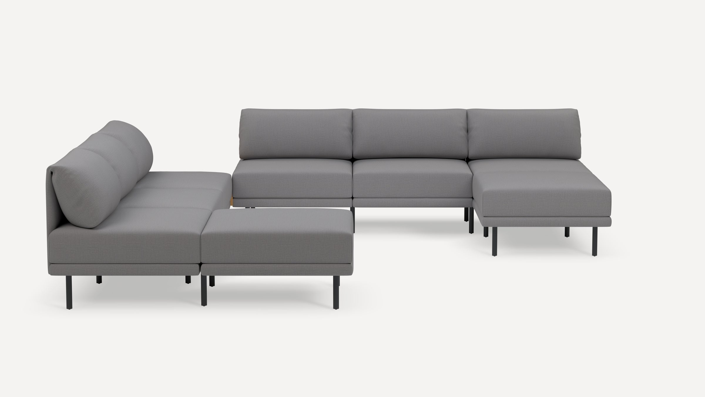 Modern gray modular sectional sofa with low backrest cushions and black metal legs, arranged in an L-shape on a white background.