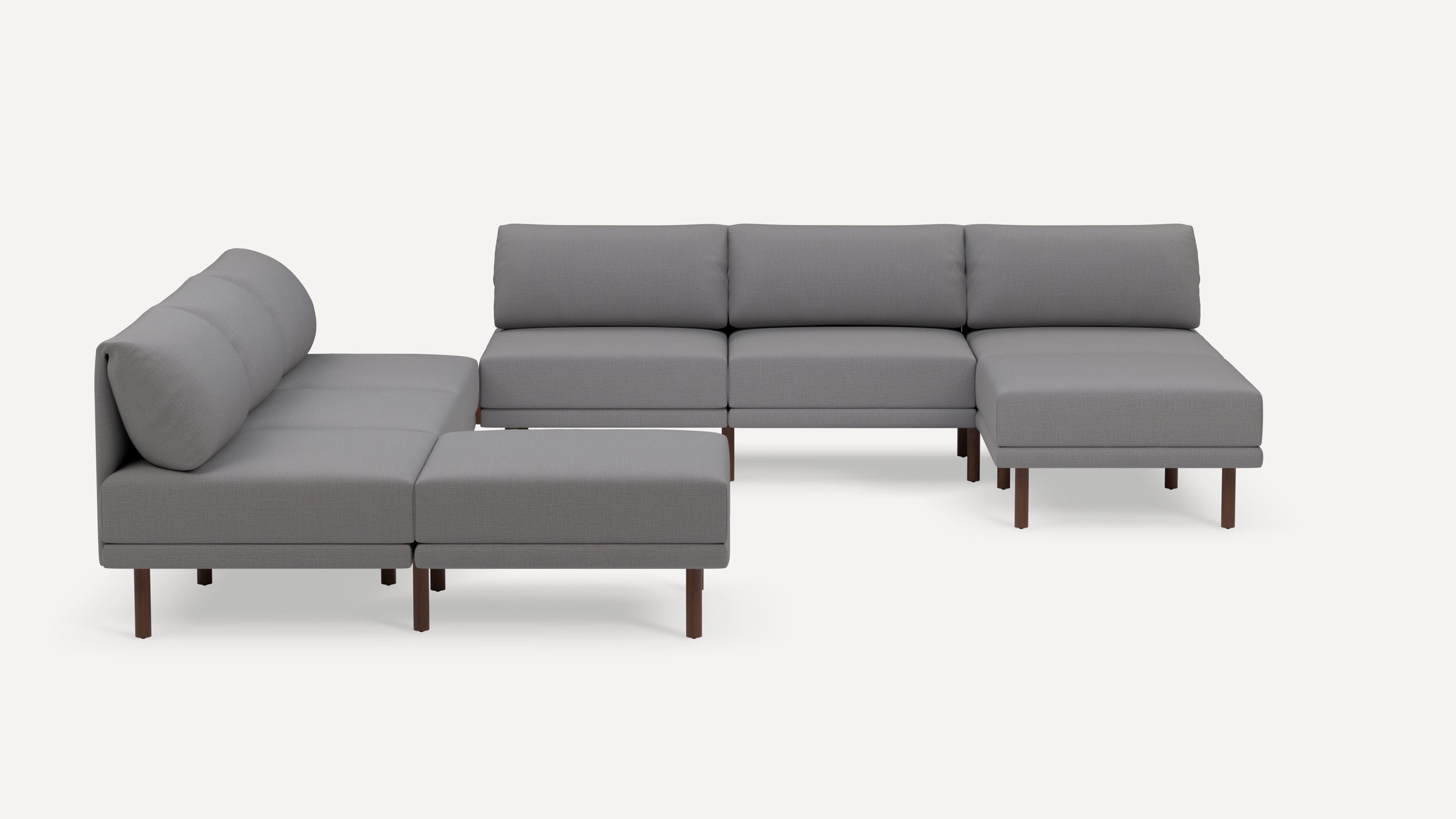 Modern gray sectional sofa with wooden legs, featuring a left chaise and ottoman, designed for living room comfort.