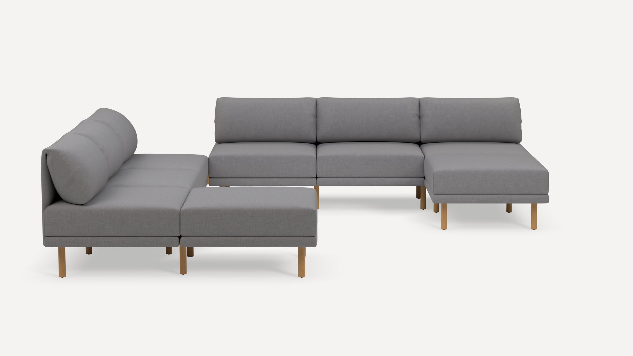 Modern sectional sofa with light gray fabric upholstery and wooden legs, featuring spacious seating and comfortable cushions.