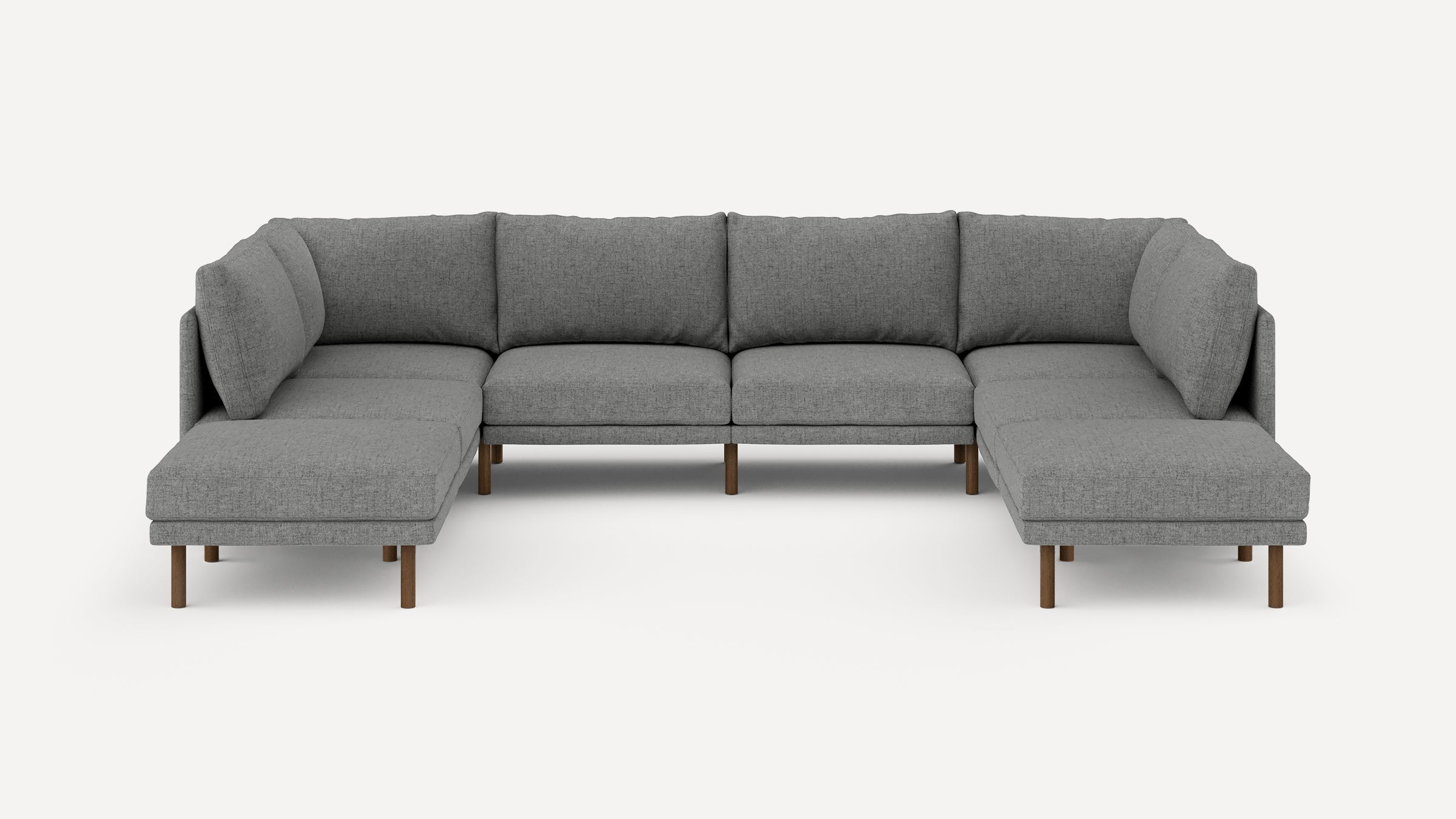 Large modern U-shaped sectional sofa with gray fabric upholstery and wooden legs, designed for spacious living areas.