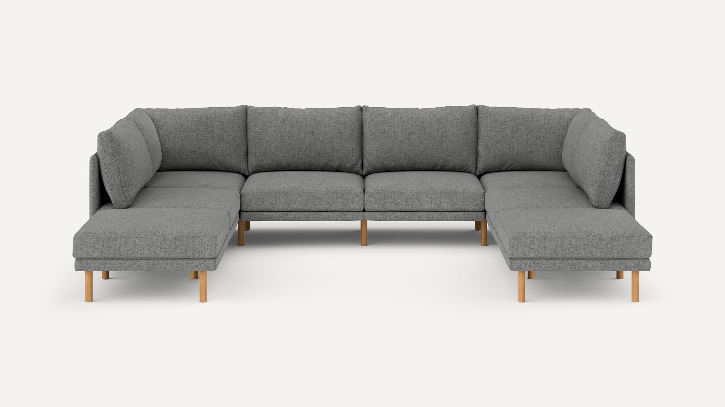 Large modern U-shaped sectional sofa with gray fabric upholstery and light wooden legs on a white background.