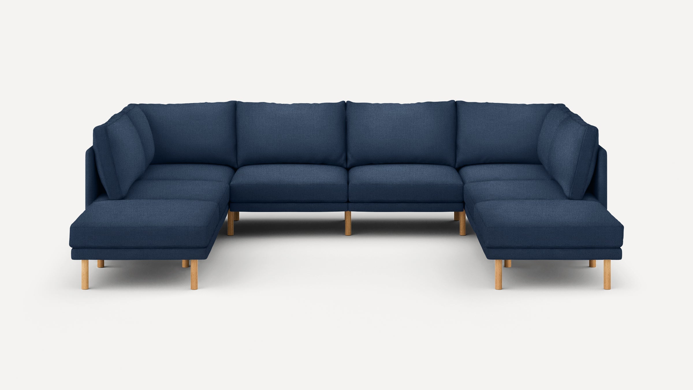 Modern navy blue fabric sectional sofa with wooden legs, featuring a spacious U-shape design for comfortable seating.