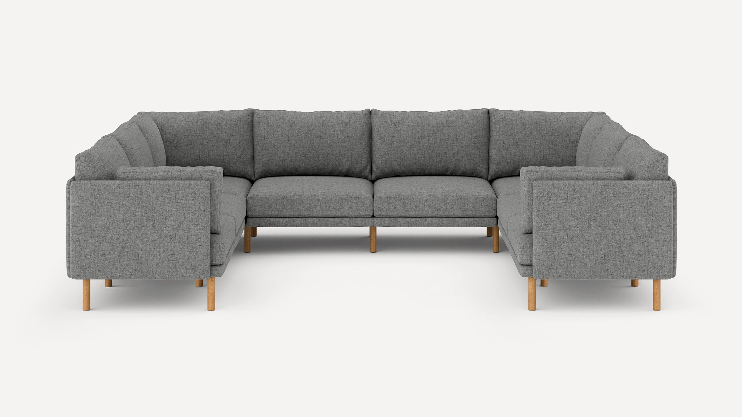Gray upholstered U-shaped sectional sofa with wooden legs, featuring cushioned seats and backrests.